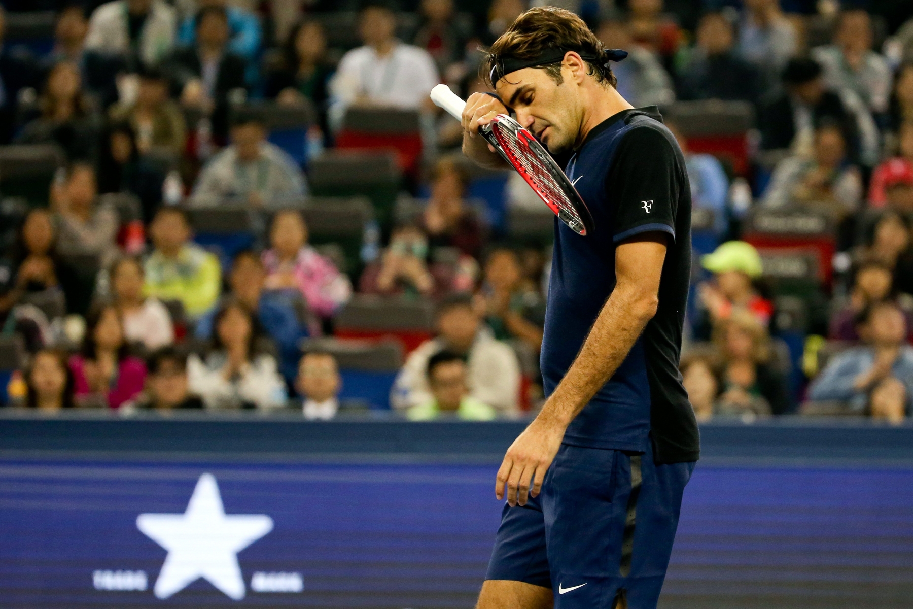 Roger Federer of Switzerland reacts while playing against Albert Ramos-Vinolas of Spain during their men's singles match at the Shanghai Masters tennis tournament in Shanghai, China Tuesday Oct. 13, 2015. (Chinatopix via AP) CHINA OUT  China Shanghai Masters Tennis