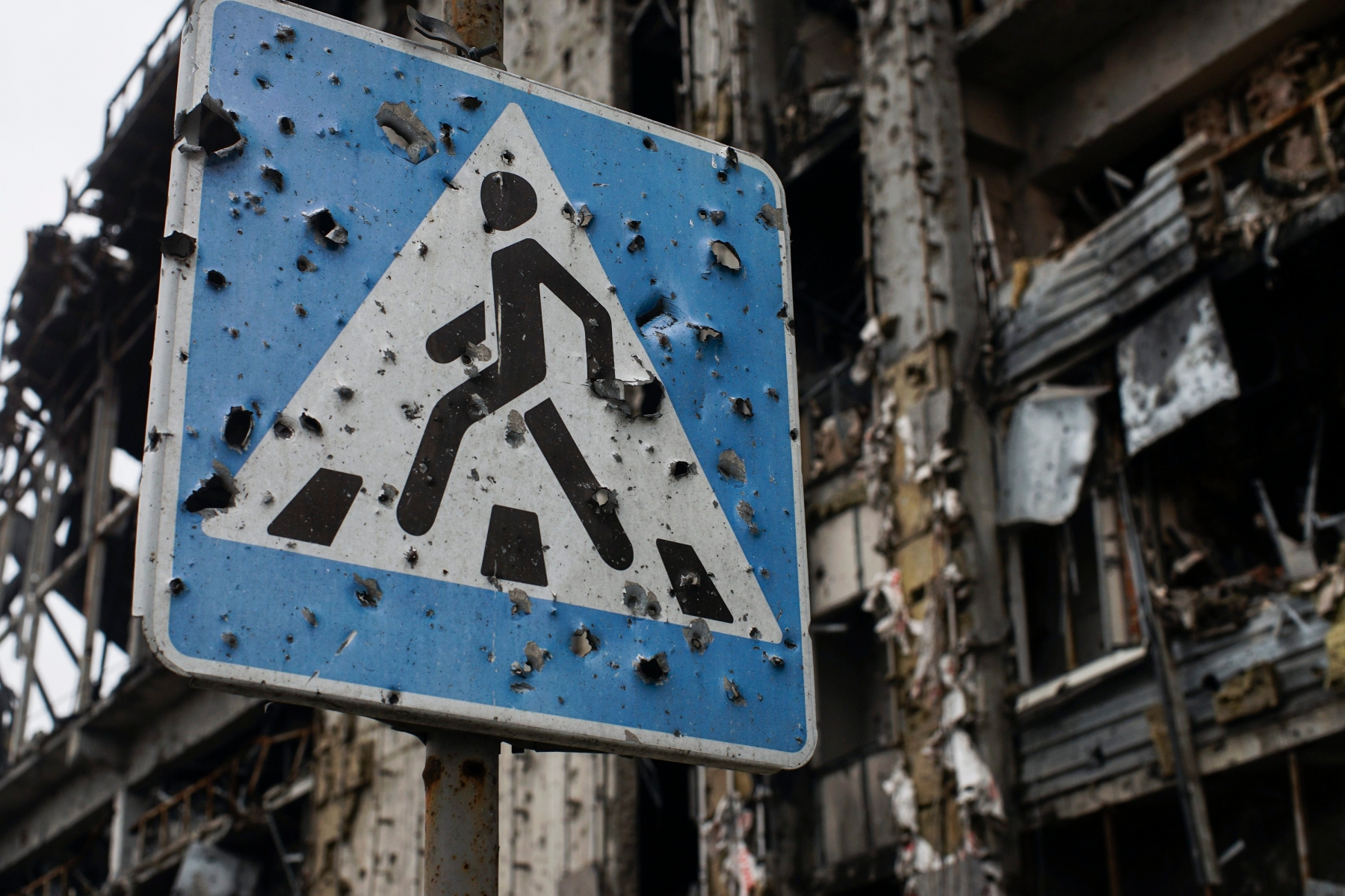 In this photo taken on Sunday, Oct.  25, 2015,  a road sign pierced by shrapnel stands at a new terminal of Donetsk Airport destroyed by shelling, in Donetsk, eastern Ukraine. The fighting has subsided, but Donetsk is quickly sinking into the past, a shabby Soviet-like state of empty streets and deprivation. Huge portraits of Josef Stalin hanging in the city center only reinforce the impression of failure. (AP Photo/Max Black) Ukraine Donetsks Dilemma