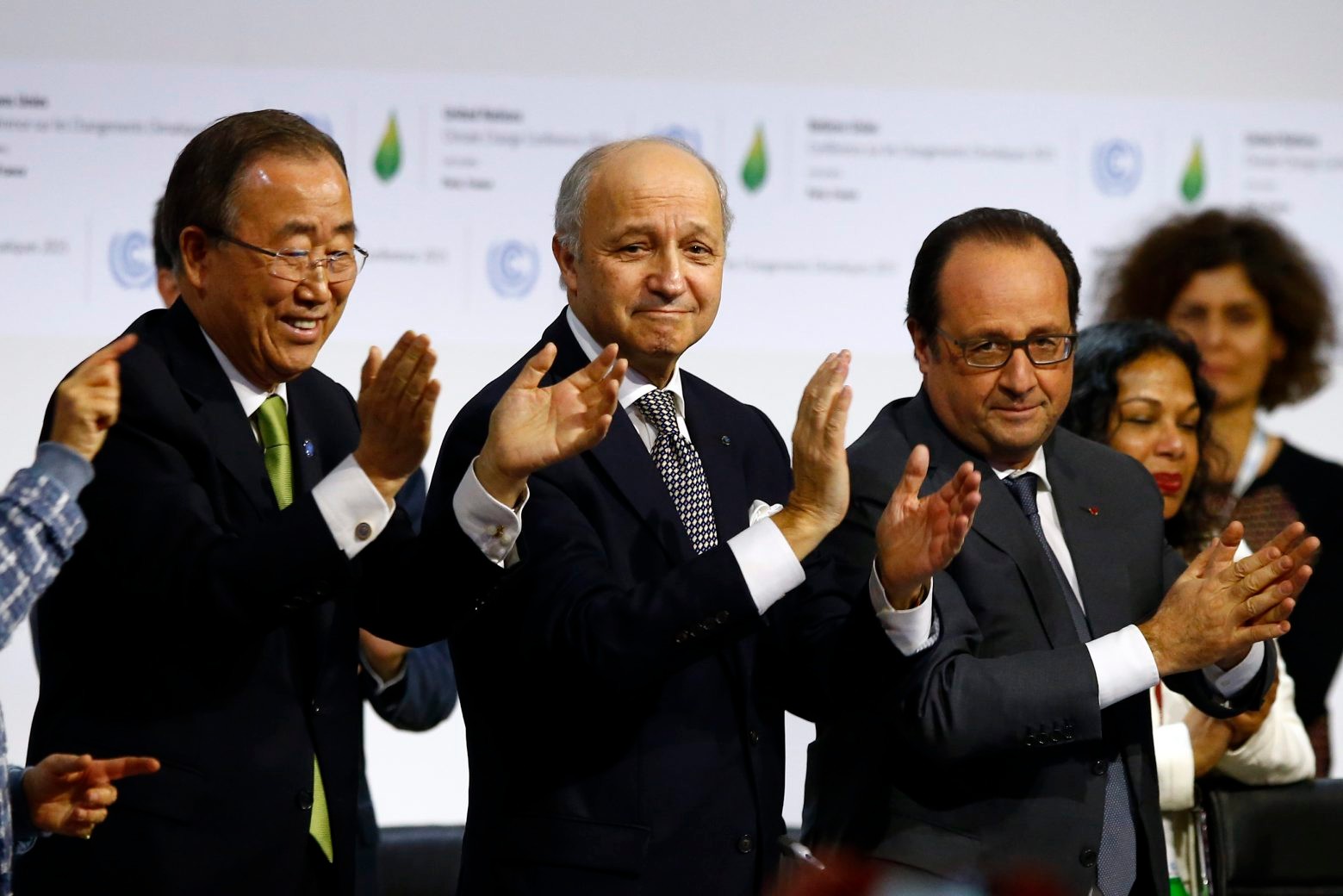 French President Francois Hollande, right, French Foreign Minister and president of the COP21 Laurent Fabius, center, and United Nations Secretary General Ban ki-Moon applaud after the final conference at the COP21, the United Nations conference on climate change, in Le Bourget, north of Paris, Saturday, Dec.12, 2015. Governments have adopted a global agreement that for the first time asks all countries to reduce or rein in their greenhouse gas emissions. (AP Photo/Francois Mori) APTOPIX France Climate Countdown