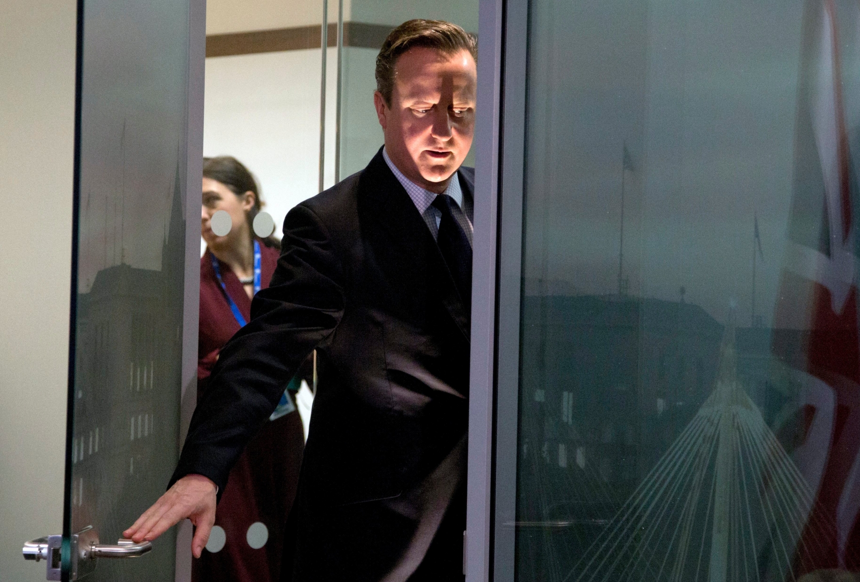 epa05073622 British Prime Minister David Cameron (R) opens the door to a meeting room as he prepares to greet Hungarian Prime Minister Viktor Orban on the sidelines of an EU summit in Brussels, Belgium, 18 December 2015. EU leaders met in Brussels for the year-end summit with highly controversial British demands for reforms expected to be discussed. Sanctions against Russia, Europe's migration crisis, the fight against terrorism and the crisis in Syria were also expected to round out the agenda of the two-days summit on 17 and 18 December.  EPA/VIRGINIA MAYO/POOL BELGIUM EU SUMMIT