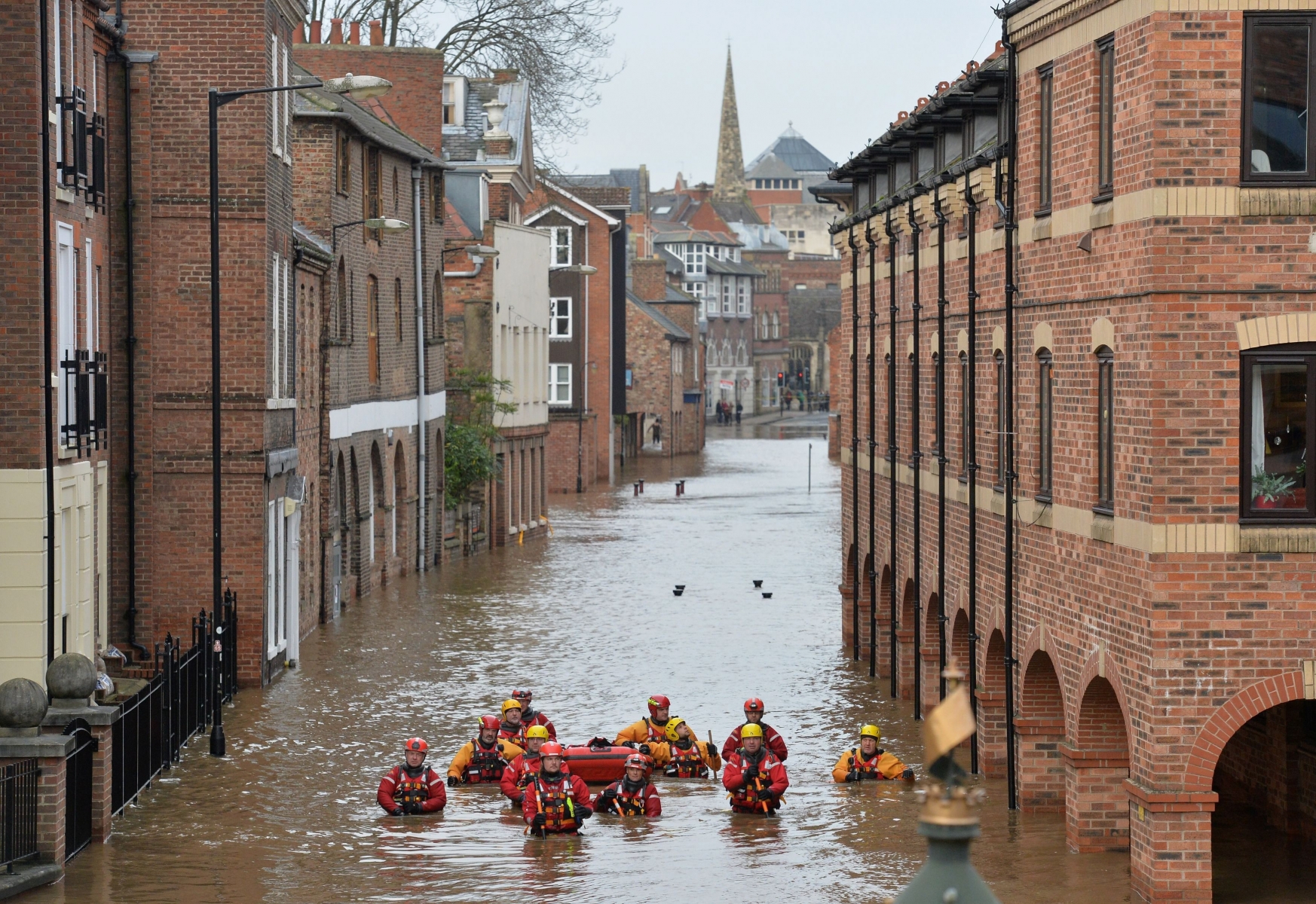 Members of the Mountain Rescue team wade through floodwater in Skeldergate, York. England, Monday, Dec. 28, 2015. British Prime Minister David Cameron sent hundreds more troops into northern England on Sunday to help exhausted residents and emergency workers fight back rising river waters that have inundated towns and cities after weeks of heavy rain. (Anna Gowthorpe/PA via AP) UNITED KINGDOM OUT NO SALES NO ARCHIVE Britain Floods