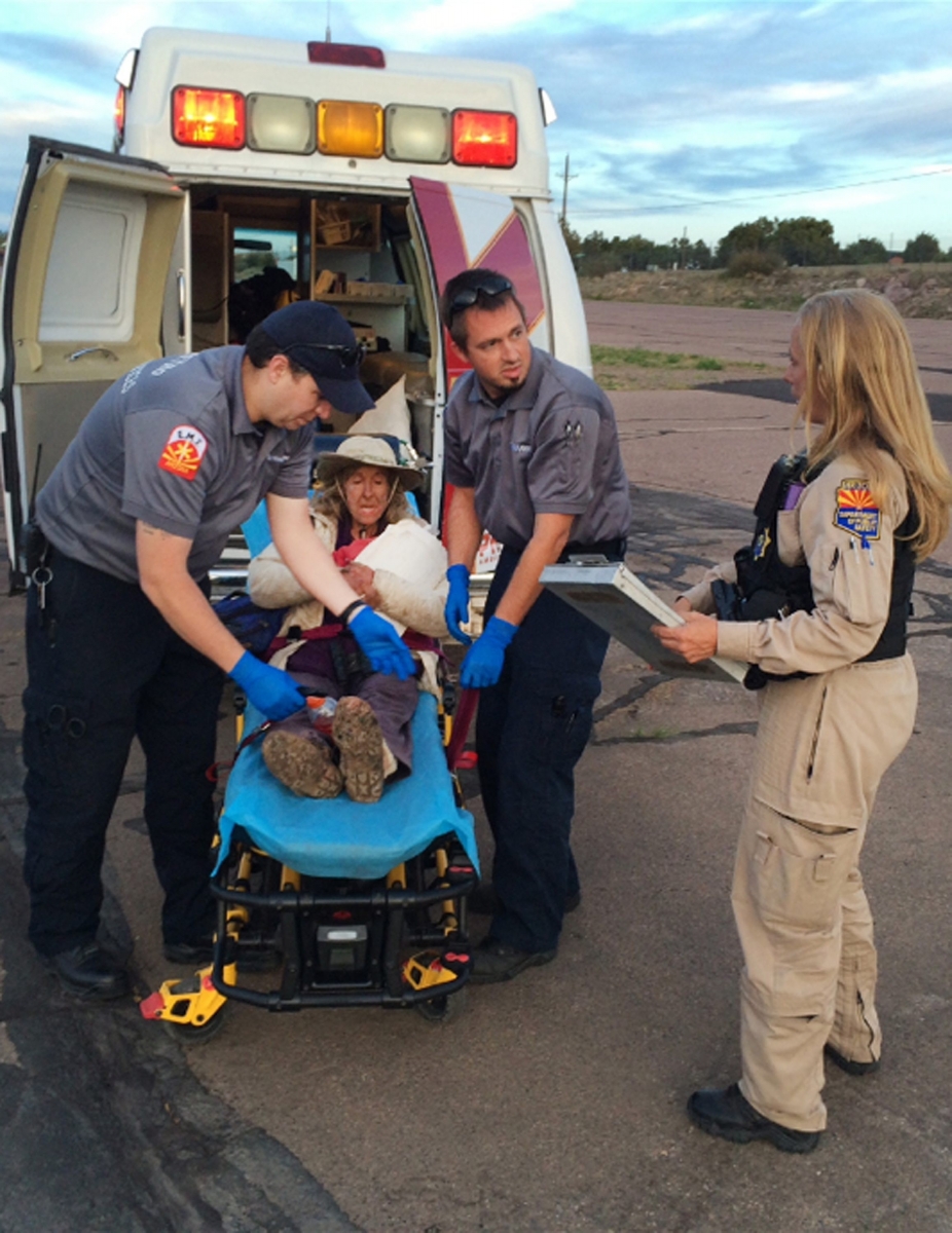 This photo taken, Saturday, April 9, 2016, and provided by Arizona Department of Public Safety shows an ambulance taking Ann Rodgers, 72 , to safety after she was lost in the forest for nine days. Rodgers got lost in the White Mountains in eastern Arizona after her hybrid car ran out of gas and battery on March 31. Rodgers survived in the forest for nine days by drinking pond water and eating plants. Authorities came across her dog April 9, and a DPS flight crew spotted a ìhelpî signal made of sticks and rocks on the ground. Rodgers had left the area, but she was found on a reservation that's home to the White Mountain Apache Tribe after starting a signal fire.  (Arizona Department of Public Safety via AP) Woman Rescued-Nine Days