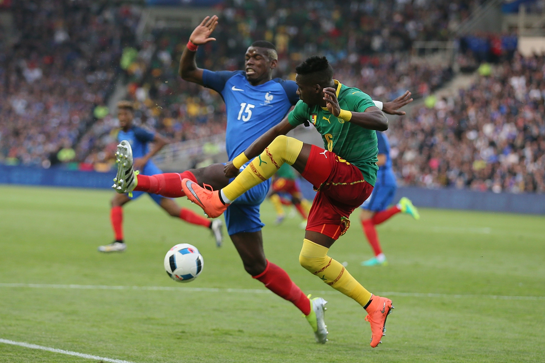 Cameroon's Ambroise Oyongo Bitolo, right, challenges for the ball with France's Paul Pogba during a friendly soccer match between France and Cameroon at the La Beaujoire Stadium in Nantes, western France, Monday, May 30, 2016. The French squad is in preparation for the EURO 2016 soccer championships which start on June 10, 2016. (AP Photo/David Vincent) France Cameroon Soccer