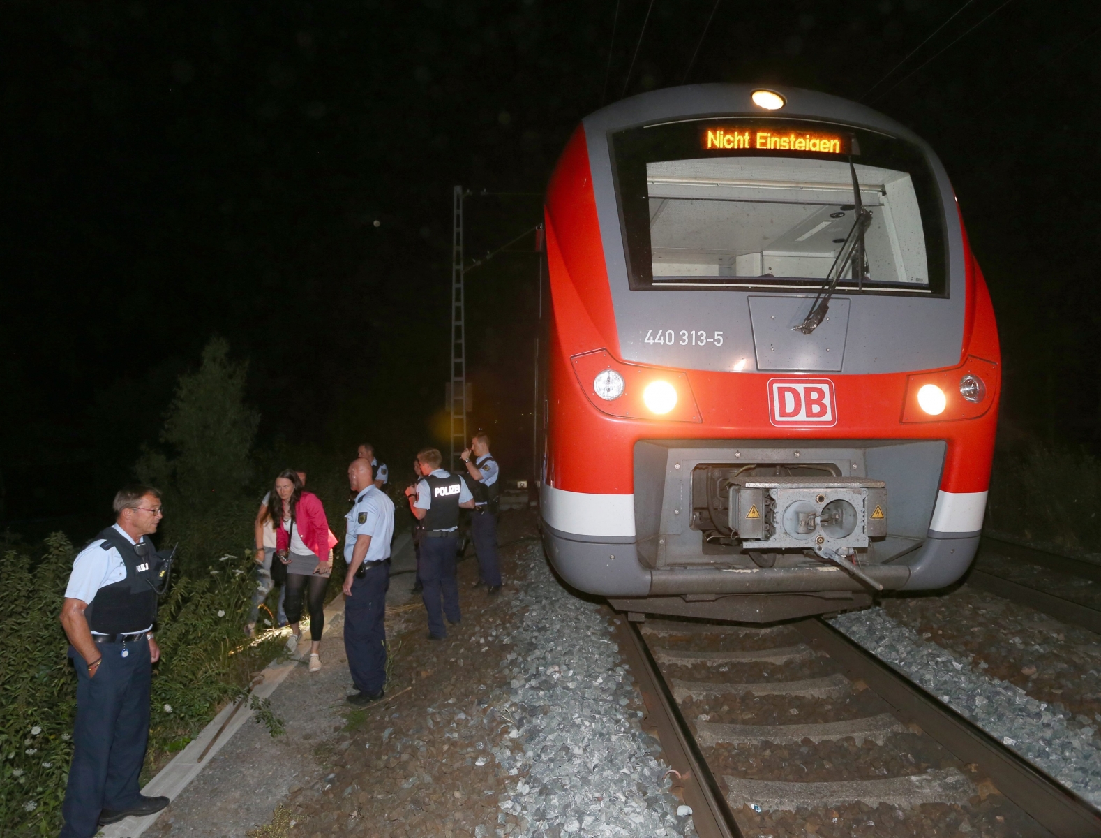 epa05431115 Police stand by the regional train on which a man allegedly wielding an axe attacked passengers in Wuerzburg, Germany, 18 July 2016. Reports state that a man allegedly wielding an axe injured multiple passengers on a regional train in Wuerzburg. The attacker was shot by police.  EPA/Karl-Josef Hildenbrand GERMANY TRAIN AXE ATTACK
