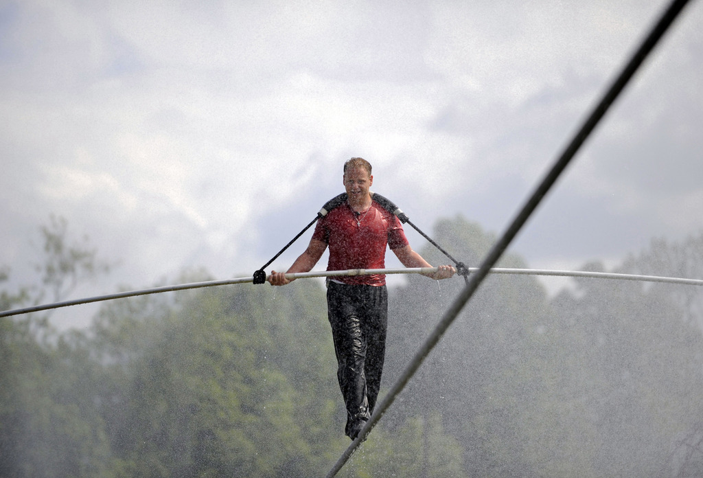 Nik Wallenda performs a walk on a tightrope during a training session in a wind driven mist in Niagara Falls, N.Y.,, Monday, May 21, 2012. (AP Photo/Gary Wiepert)