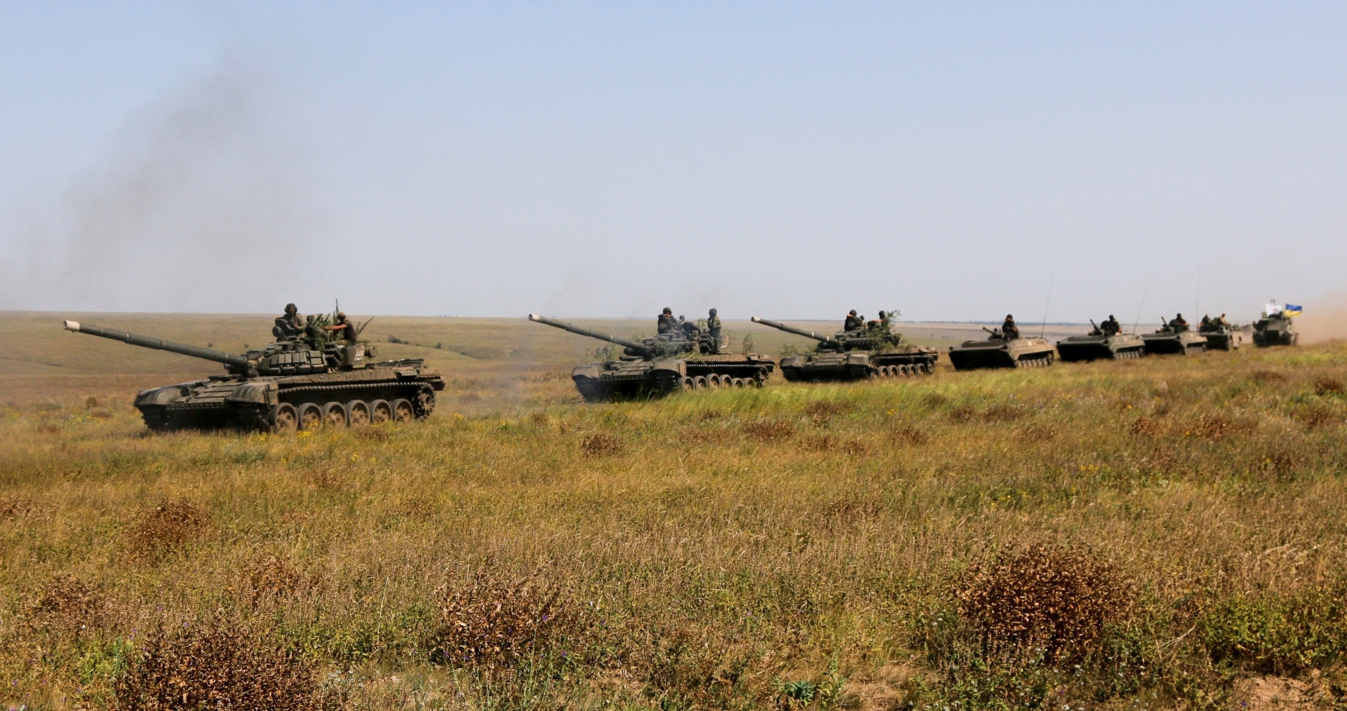 A column of Ukrainian tanks and APCs move towards the de-facto border with Crimea near Kherson, southern Ukraine, Friday, Aug. 12, 2016. Ukraine put its troops on combat alert Thursday along the country's de-facto borders with Crimea and separatist rebels in the east amid an escalating war of words with Russia over Crimea. (AP Photo/Aleksandr Shulman) Ukraine Russia