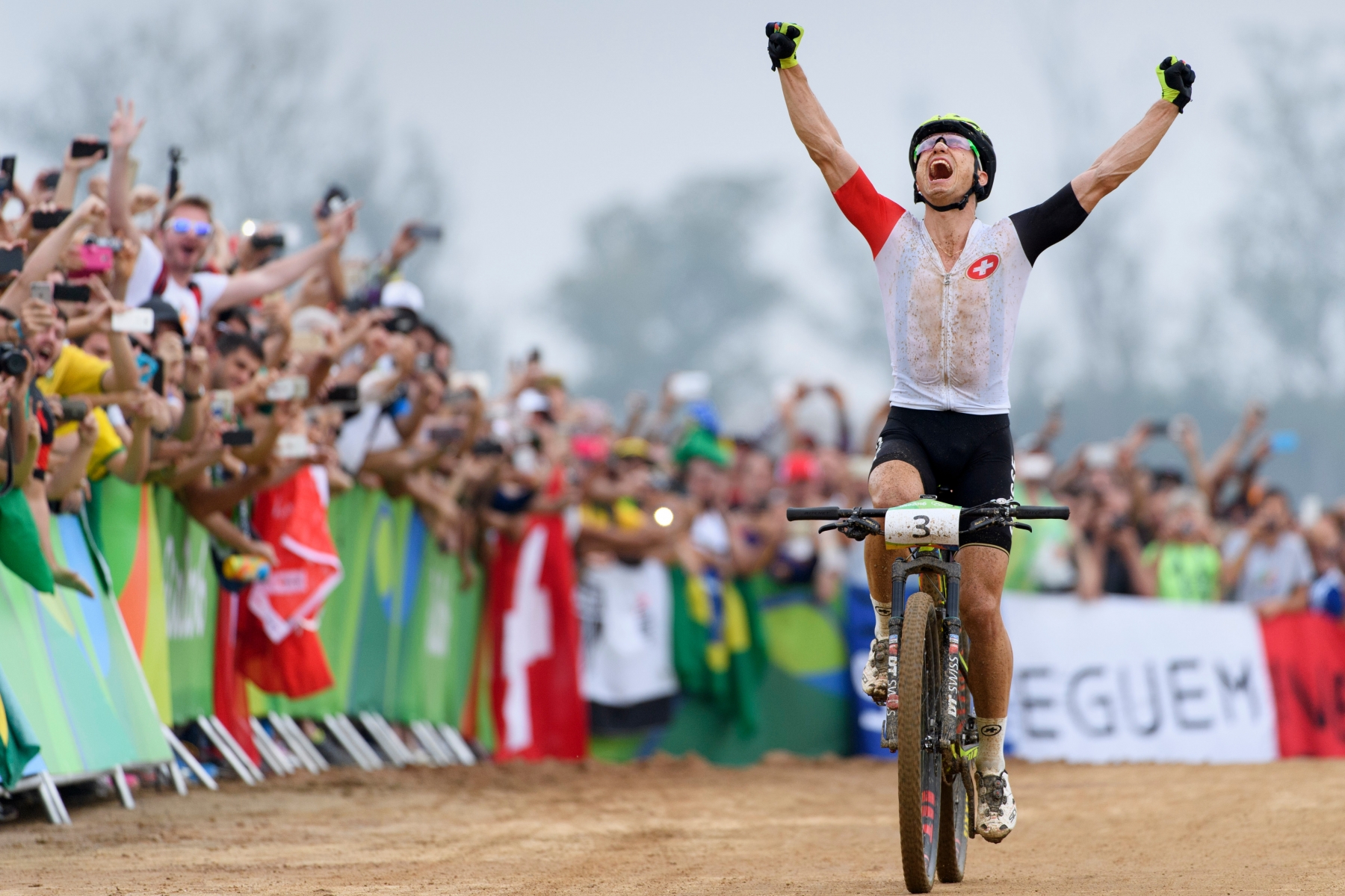 Gold medalist Nino Schurter of Switzerland celebrates as he cross the finish line of the men's MTB cross country race in the Mountain Bike Center in Deodoro at the Rio 2016 Olympic Summer Games in Rio de Janeiro, Brazil, on Sunday, August 21, 2016. (KEYSTONE/Laurent Gillieron) BRAZIL RIO OLYMPICS 2016 CYCLING MTB