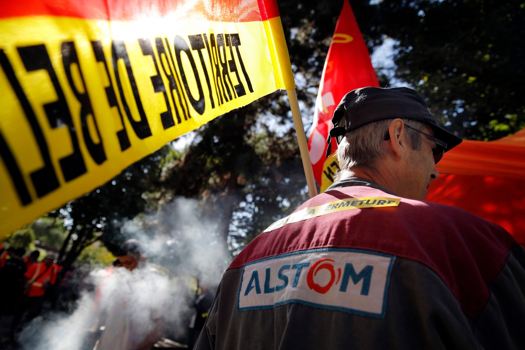 Alstom employers stage a protest in front of its headquarters in St Ouen, north of Paris, asking not to close a plant in Belfort, eastern France, which employs 400 people, Tuesday, Sept. 27, 2016. Alstom's situation is considered by many French politicians as symbolic of France's difficulty of keeping a strong industry at home. (AP Photo/Christophe Ena) France Alstom