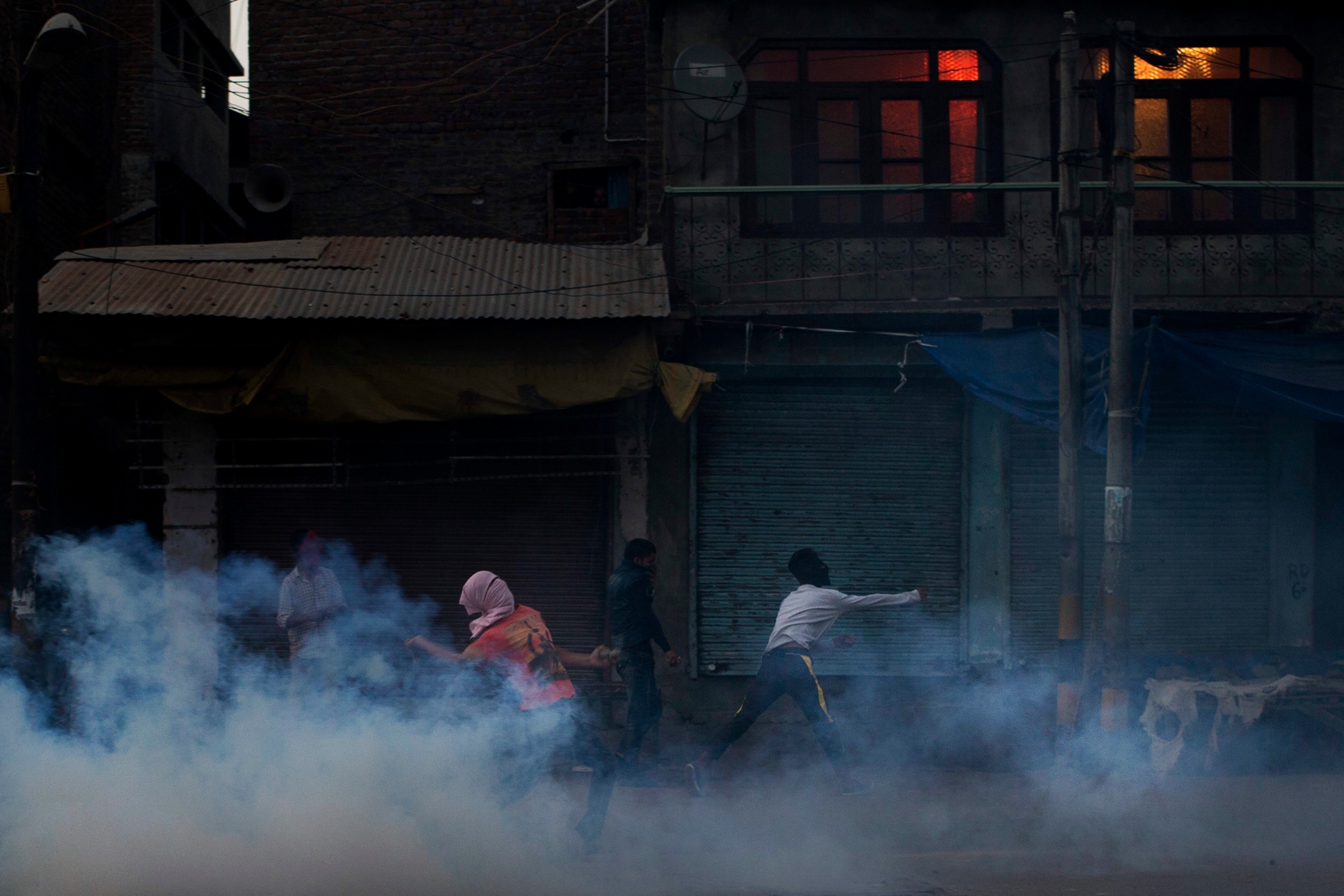 Kashmiri protesters prepare to throw exploded tear gas shell back at Indian police men during a protest after funeral prayers in absentia for Pakistani soldiers killed in cross border firing in Srinagar, Indian controlled Kashmir, Thursday, Sept. 29, 2016. Pakistan on Thursday said two of its soldiers were killed in an "unprovoked" attack when India fired across the border of the disputed region of Kashmir, while India said it had carried out a "surgical strike" against terrorists, in an exchange that marks an escalation in tensions between the uneasy and nuclear-armed neighbors. Pakistan and India often trade fire in Kashmir, a Himalayan region that is split between the two countries and claimed by both in its entirety. (AP Photo/Dar Yasin) India Pakistan Kashmir