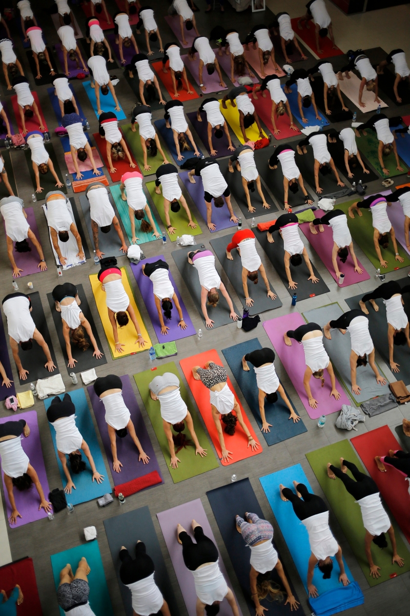 epa04126278 Yogis practice sun salutations during a session in a popular shopping mall in Johannesburg, South Africa, 15 March 2014. The yogi's did 108 sun salutations in order to raise awareness and money for Yoga Stops Traffick. The worldwide movement aims the awareness at trying to stop human trafficking in Africa and India.  EPA/KIM LUDBROOK SOUTH AFRICA YOGA STOPS TRAFFICK