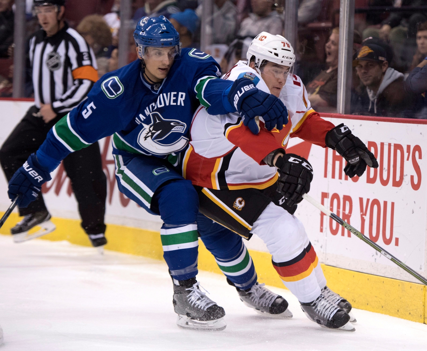 Vancouver Canucks defenseman Luca Sbisa (5) fights for control of the puck with Calgary Flames left wing Micheal Ferland (79) during the first period of an NHL hockey game in Vancouver on Saturday, Oct. 15, 2016. (Jonathan Hayward/The Canadian Press via AP) Flames Canucks Hockey