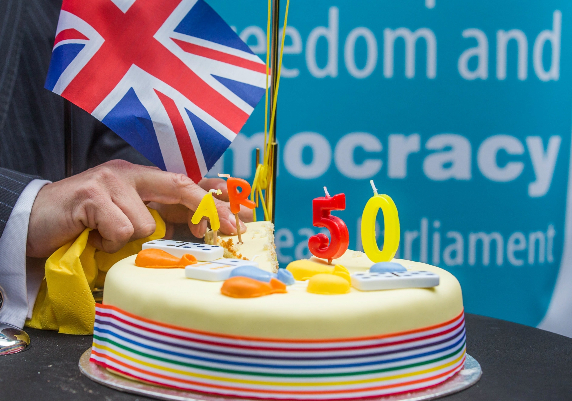 epa05877078 A member of Britain's UK Independence Party (UKIP) takes a slice of cake to celebrate the official triggering of Article 50 of the Lisbon Treaty, dubbed 'Brexit', at the Old Hack Pub in front of the EU Commission in Brussels, Belgium, 29 March 2017. The British ambassador to the EU, Sir Tim Barrow, earlier 0n n29 March handed over the official notice under Article 50 of the Lisbon Treaty to European Council President Donald Tusk as part of the process that starts the formal proceedings of the United Kingdom leaving the European Union. Britain's Prime Minister had signed the notice following the June 2016 referendum to vote on Britain staying or leaving the European Union.  EPA/STEPHANIE LECOCQ BELGIUM EU BRITAIN  BREXIT