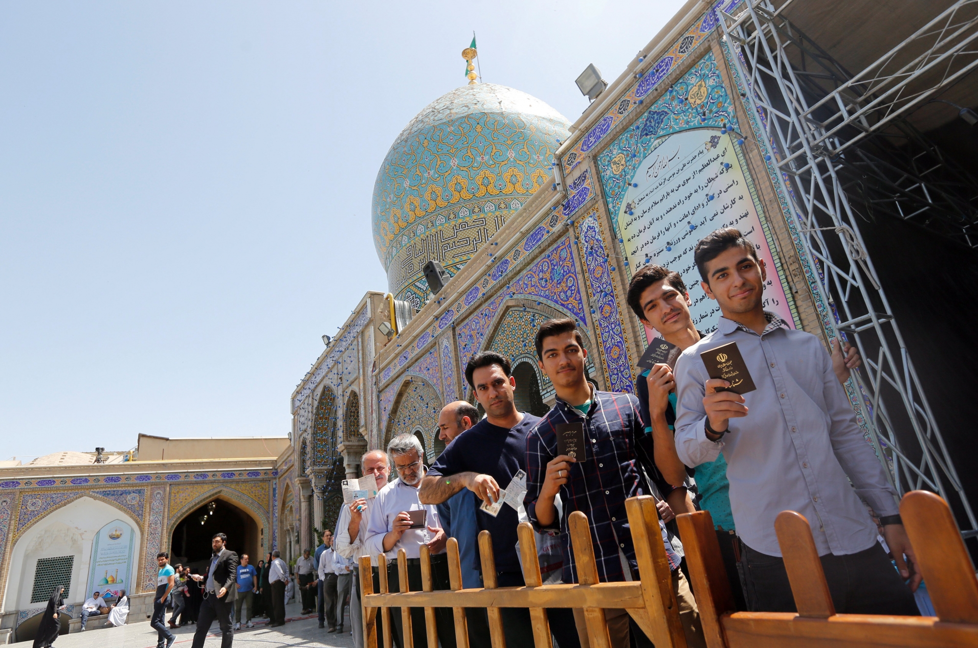 epa05973674 Iranian men waits in line to cast their ballots in the Iranian presidential elections at a polling station set up at the Abdol Azim shrine in the city of Shahre-Ray, south of the capital of Tehran, Iran, 19 May 2017. Out of the group of candidates, the race is tightest between frontrunners Iranian current president Hassan Rouhani and his conservative challenger Ebrahim Raisi.  EPA/ABEDIN TAHERKENAREH IRAN ELECTIONS