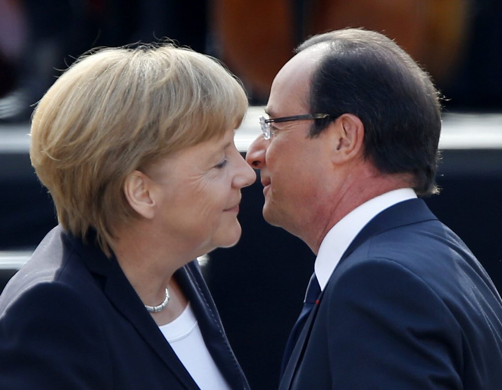 German Chancellor Angela Merkel, left, and French President Francois Hollande hug in the yard of the castle in Ludwigsburg, Germany, Saturday, Sept.22, 2012. Merkel and Hollande attend the celebration of the 50th anniversary of former French President Charles de Gaulle's speech to the youth of Germany. (AP Photo/Michael Probst)