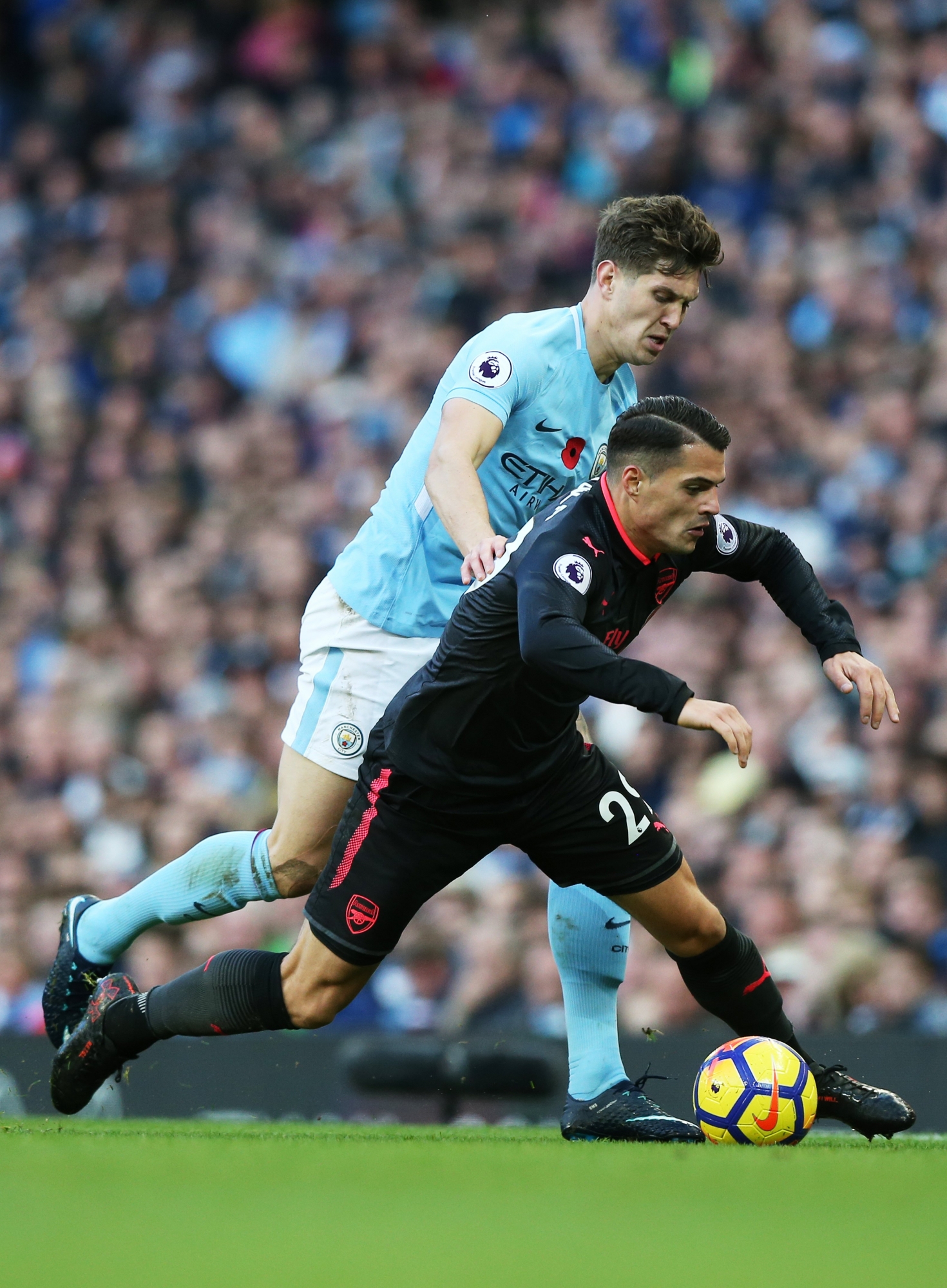 epa06310143 Granit Xhaka (R) of Arsenal in action against John Stones of Manchester City during the English Premier League match between Manchester City and Arsenal at the Etihad Stadium in Manchester, Britain, 05 November 2017.  EPA/NIGEL RODDIS No use with unauthorised audio, video, data, fixture lists, club/league logos 'live' services. Online in-match use limited to 75 images, no video emulation. No use in betting, games or single club/league/player publications.  EDITORIAL USE ONLY BRITAIN SOCCER ENGLISH PREMIER LEAGUE