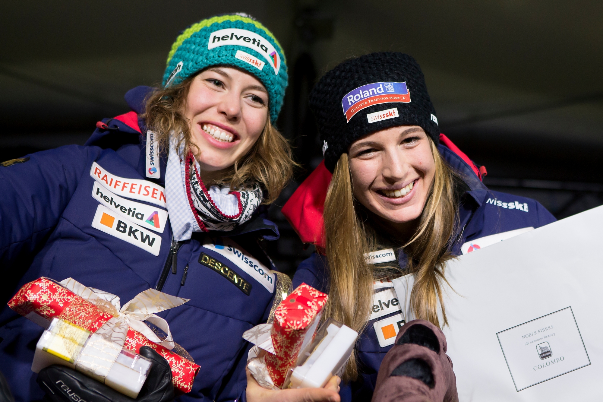Michelle Gisin of Switzerland, left, second place, and winner Jasmine Flury of Switzerland, right, celebrate during the Awards ceremony of the women's Super-G at the FIS Alpine Ski World Cup, in St. Moritz, Switzerland, Saturday, December 9, 2017. (KEYSTONE/Alexandra Wey) SWITZERLAND ALPINE SKIING WORLD CUP ST. MORITZ