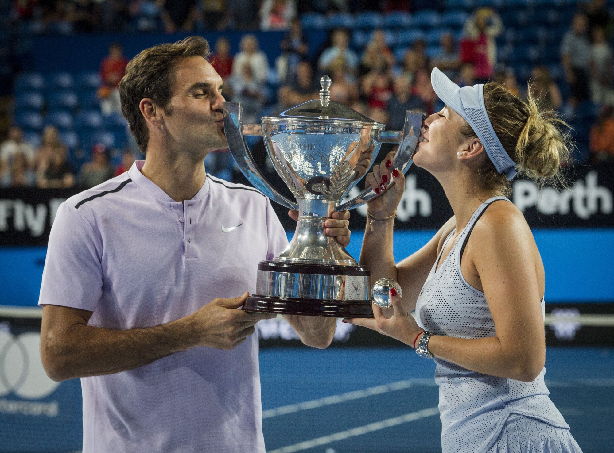 epa06420720 Roger Federer and Belinda Bencic of Switzerland celebrate their finals win with the Hopman Cup after winning on the final day of the Hopman Cup final between Switzerland and Germany at the Perth Arena in Perth, Australia, 06 January 2018.  EPA/TONY MCDONOUGH AUSTRALIA AND NEW ZEALAND OUT  EDITORIAL USE ONLY  EDITORIAL USE ONLY  EDITORIAL USE ONLY  EDITORIAL USE ONLY  EDITORIAL USE ONLY  EDITORIAL USE ONLY AUSTRALIA TENNIS HOPMAN CUP