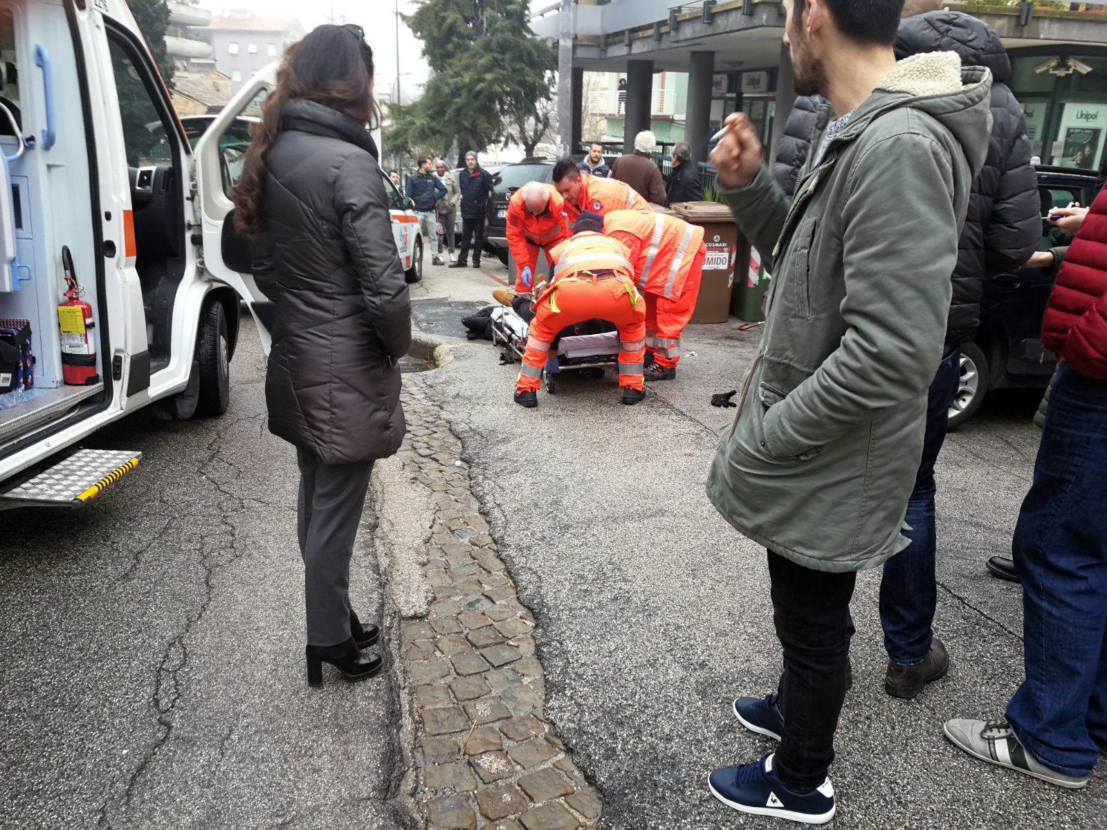 epaselect epa06493400 Paramedics treat an injured person that was shot from a passing vehicle in Macerata, Italy, 03 February 2018. According to the local authorities, the town at the eastern Italian coast near Ancona is under a lockdown due to shots being fired from a car that is driving around in the town for yet unknown reasons.  EPA/GUIDO PICCHIO epaselect ITALY CRIME MACERATA SHOOTING