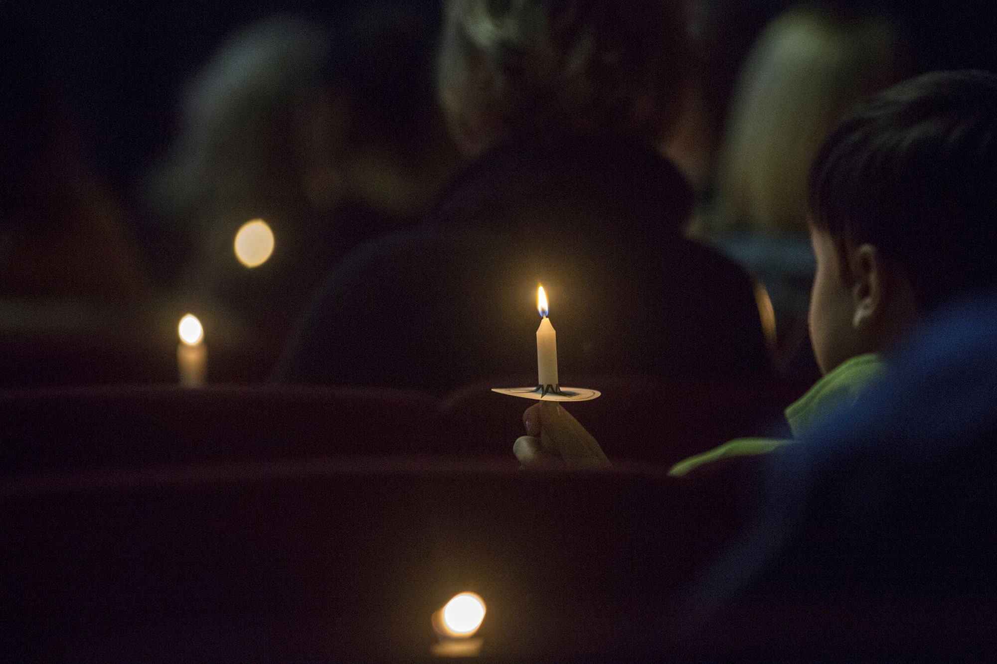 People hold candles during a vigil at Impact Church in Benton, Ky., Tuesday Jan. 23, 2018. The vigil was held for victims of the Marshall County High School shooting earlier in the day. (Ryan Hermens/The Paducah Sun via AP) SCHOOL SHOOTING-KENTUCKY