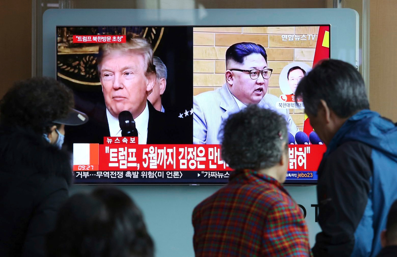 People watch a TV screen showing North Korean leader Kim Jong Un and U.S. President Donald Trump, left, at the Seoul Railway Station in Seoul, South Korea, Friday, March 9, 2018. Trump has accepted an offer of a summit from the North Korean leader and will meet with Kim Jong Un by May, a top South Korean official said Thursday, in a remarkable turnaround in relations between two historic adversaries. The signs read: " Trump has accepted an offer of a summit from the North Korean leader and will meet with Kim by May." (AP Photo/Ahn Young-joon) South Korea US North Korea
