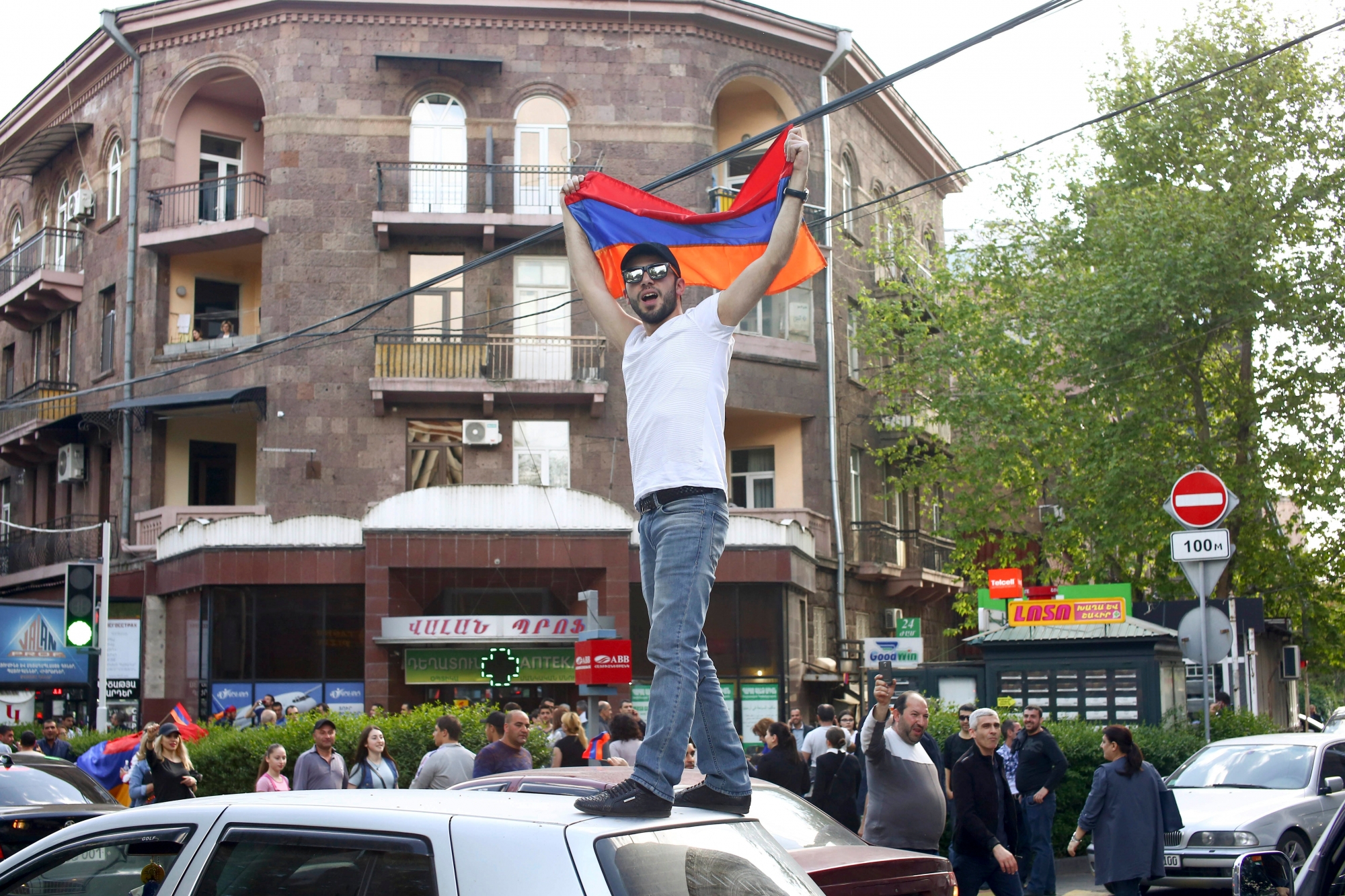 A man waves an Armenian national flag celebrating Armenian Prime Minister's Serzh Sargsyan's resignation in Republic Square in Yerevan, Armenia, Monday, April 23, 2018. Armenian Prime Minister Serzh Sargsyan resigned unexpectedly on Monday to quell massive anti-government protests over what critics feared was his effort to seize power for life.  (Hrant Khactaryan/PAN Photo via AP) Armenia Protest