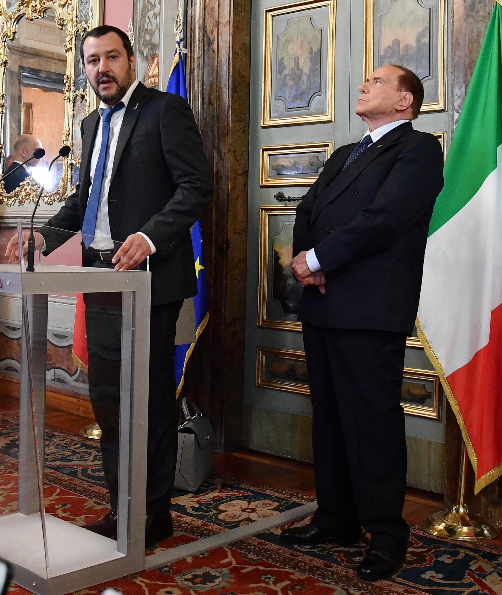 Leader of The League party, Matteo Salvini, left, is flanked by Forza Italia party's leader Silvio Berlusconi as they address the media after meeting Senate president Maria Elisabetta Alberti Casellati in Rome, Thursday, April 19, 2018. Italy's president on Wednesday tapped the Senate president, a longtime supporter of ex-Premier Silvio Berlusconi, to explore possible alliances to create a governing majority in Parliament, more than a month after Italy's inconclusive elections. (Ettore Ferrari/ANSA via AP) Italy Politics