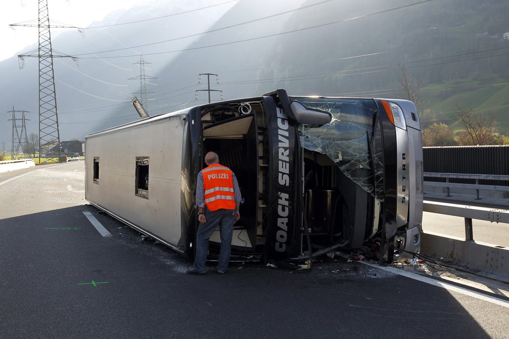 A tour bus is lying on it's side on the A2 highway near Schattdorf, Switzerland, Sunday, November 25, 2012. The Marcus Miller band was involved in an accident on the highway A2 between Erstfeld and Flueelen, Switzerland, Sunday, November 25, 2012. Coming from Monaco the band was on their way to Holland to play in Hengelo on their European tour. One of the two drivers was killed, all the eleven band members and the second driver were injured. Thre was no other vehicel involved in the accident. (KEYSTONE/Urs Flueeler)