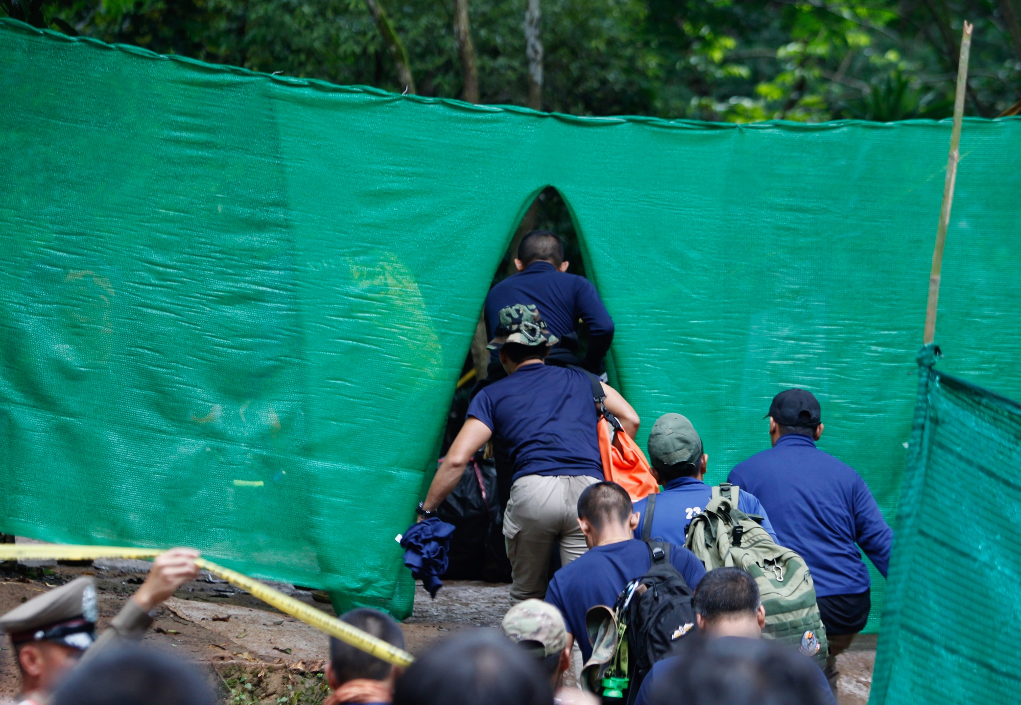 epa06873276 Thai military personnel walk inside the blocking area during rescue operations to save a soccer team at Tham Luang cave in Khun Nam Nang Non Forest Park, Chiang Rai province, Thailand, 08 July 2018. The officials' operations are underway to safely bring out the 13 members of the youth soccer team including their assistant coach who have been trapped in Tham Luang cave since 23 June 2018.  EPA/PONGMANAT TASIRI THAILAND ACCIDENTS CAVE