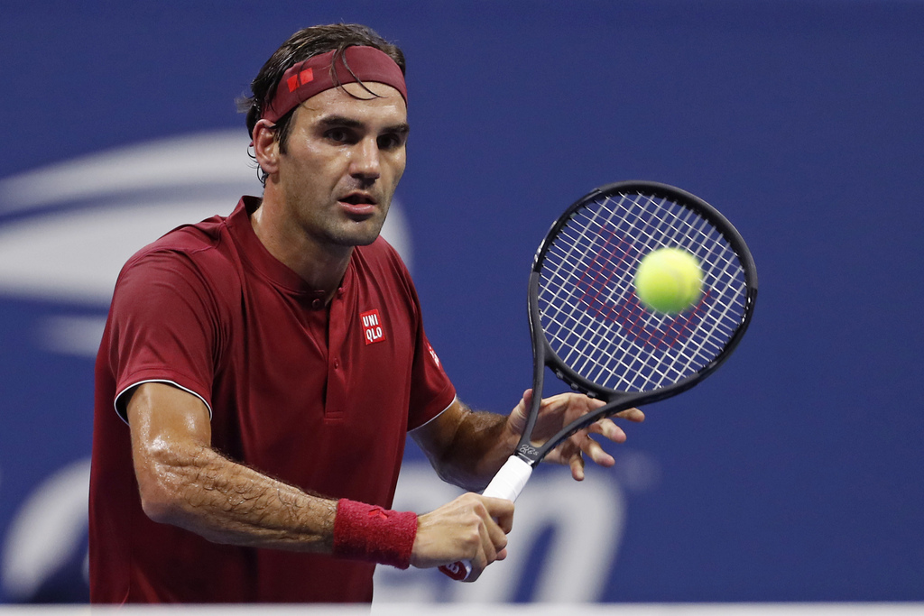 Roger Federer, of Switzerland, returns a shot to John Millman, of Australia, during the fourth round of the U.S. Open tennis tournament, Monday, Sept. 3, 2018, in New York. (AP Photo/Adam Hunger)