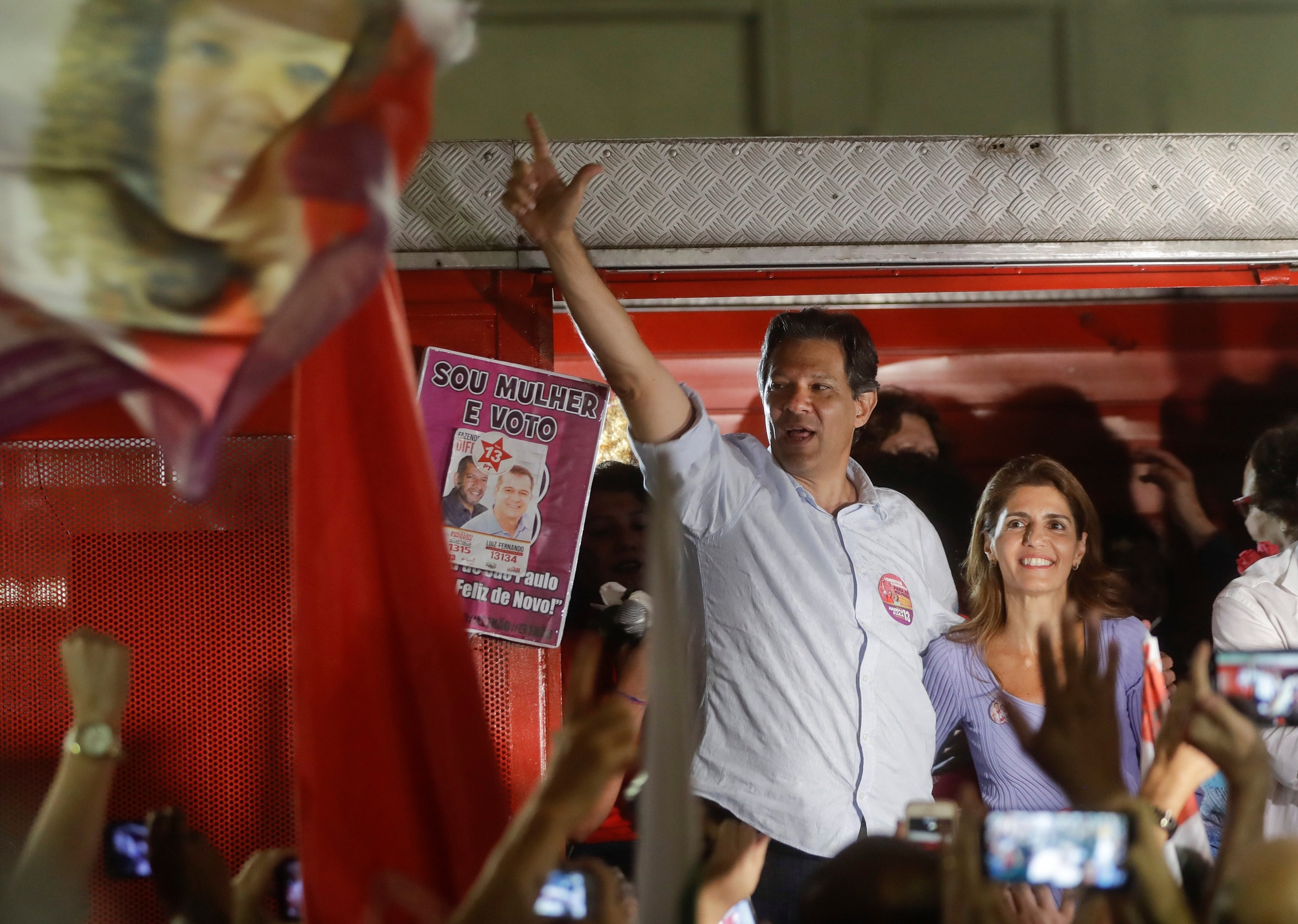 Presidential candidate for the Workers Party, Fernando Haddad, stands with his wife Ana Estela Haddad during a meeting with women as he campaigns in Sao Paulo, Brazil, Tuesday, Sept. 25, 2018. Brazil will hold general elections on Oct. 7. (AP Photo/Andre Penner) Brazil Elections