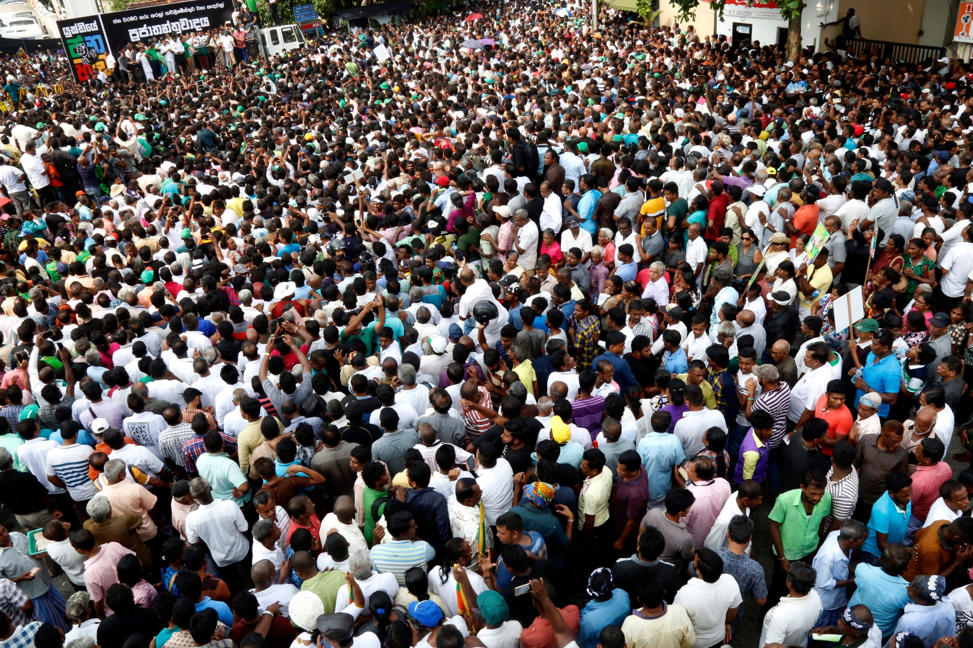 epa07131535 A view of a section of supporters of United National Party (UNP) leader Ranil Wickremesinghe taking part in a rally near the Prime Ministerial residence of the 'Temple Trees' in Colombo, Sri Lanka, 30 October 2018. Sri Lankan President Maithripala Sirisena appointed Mahinda Rajapaksa as the new Prime Minister after removing Ranil Wickremesinghe from the post on 26 October night. Ousted premier Wickremesinghe claims that constitutionally he still retains the post of Prime Minister refusing to leave the official Prime Ministerial residence of the 'Temple Trees.' Thousands of demonstrators took part in the rally, organized in solidarity with Wickremesinghe, to show what the UNP claimed to be as the 'people's power.' Meanwhile, 12 Ministers, a Deputy Minister and two State Ministers, including five from the UNP have already taken oaths under the government of newly appointed Prime Minister Rajapaksa.  EPA/M.A.PUSHPA KUMARA SRI LANKA POLITICS CRISIS