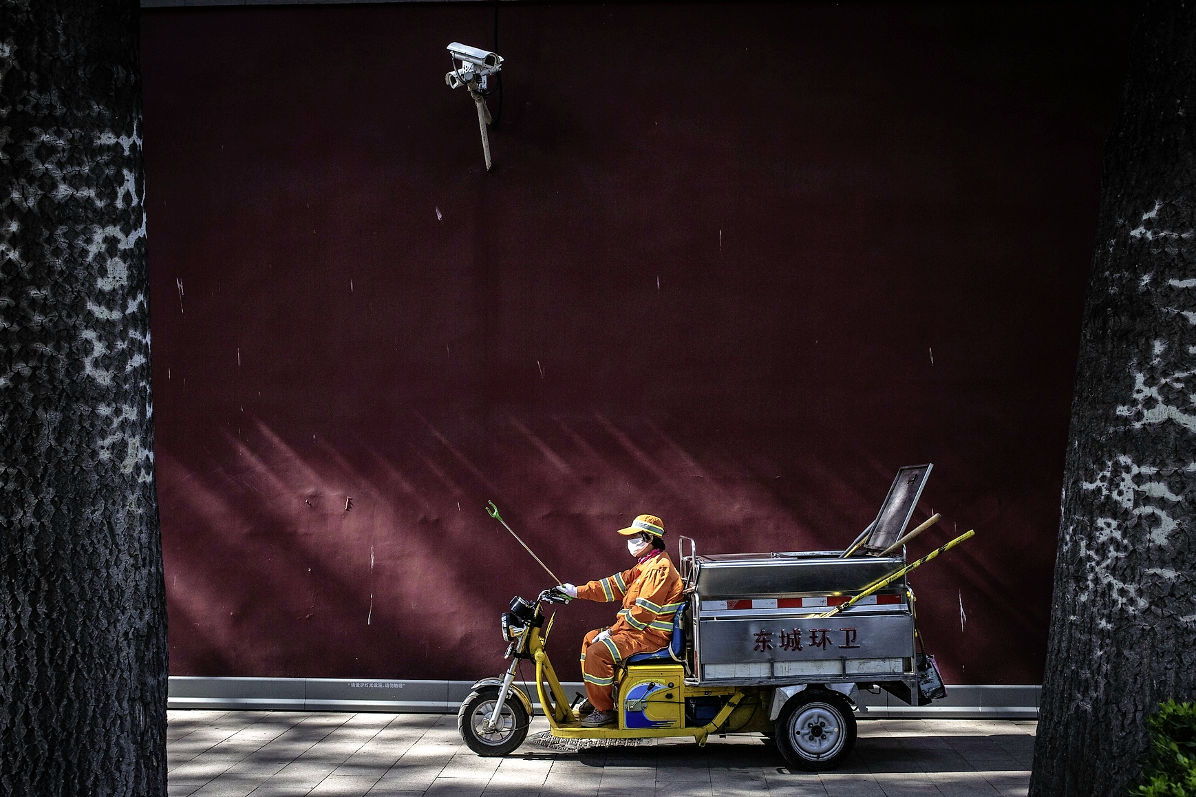 epa06007540 A municipal worker cleans the street as a security camera observes the area next to Tiananmen Square in Beijing, China, 03 June 2017. The 28-year-anniversary of the 1989 Tiananmen Square military crackdown falls on 04 June and Chinese authorities have raised the security level in the area drastically. Between 15 April and 04 June 1989, students, intellectuals, and activists engaged in a series of demonstrations against the Chinese Communist Party and although the protests took place all over the country, they centered on Tiananmen Square in Beijing, where the subsequent crackdown by authorities caused a vast number of civilians' deaths and injuries.  EPA/ROMAN PILIPEY CHINA TIANANMEN SQUARE ANNIVERSARY