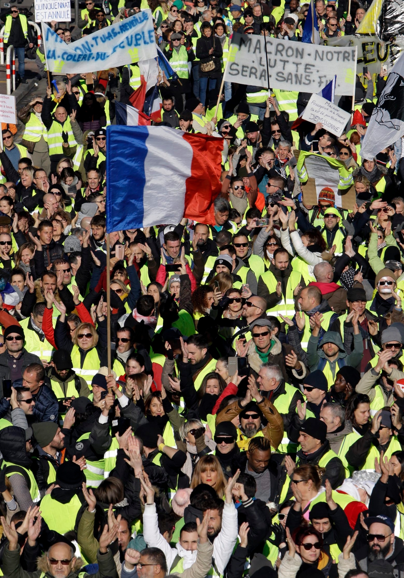 People demonstrate Saturday, Dec. 15, 2018 in Marseille, southern France. Paris police deployed in large numbers Saturday for the fifth straight weekend of demonstrations by the "yellow vest" protesters, with authorities repeating calls for calm after protests on previous weekends turned violent. At least 21 people were detained beforehand. (AP Photo/Claude Paris) France Protests