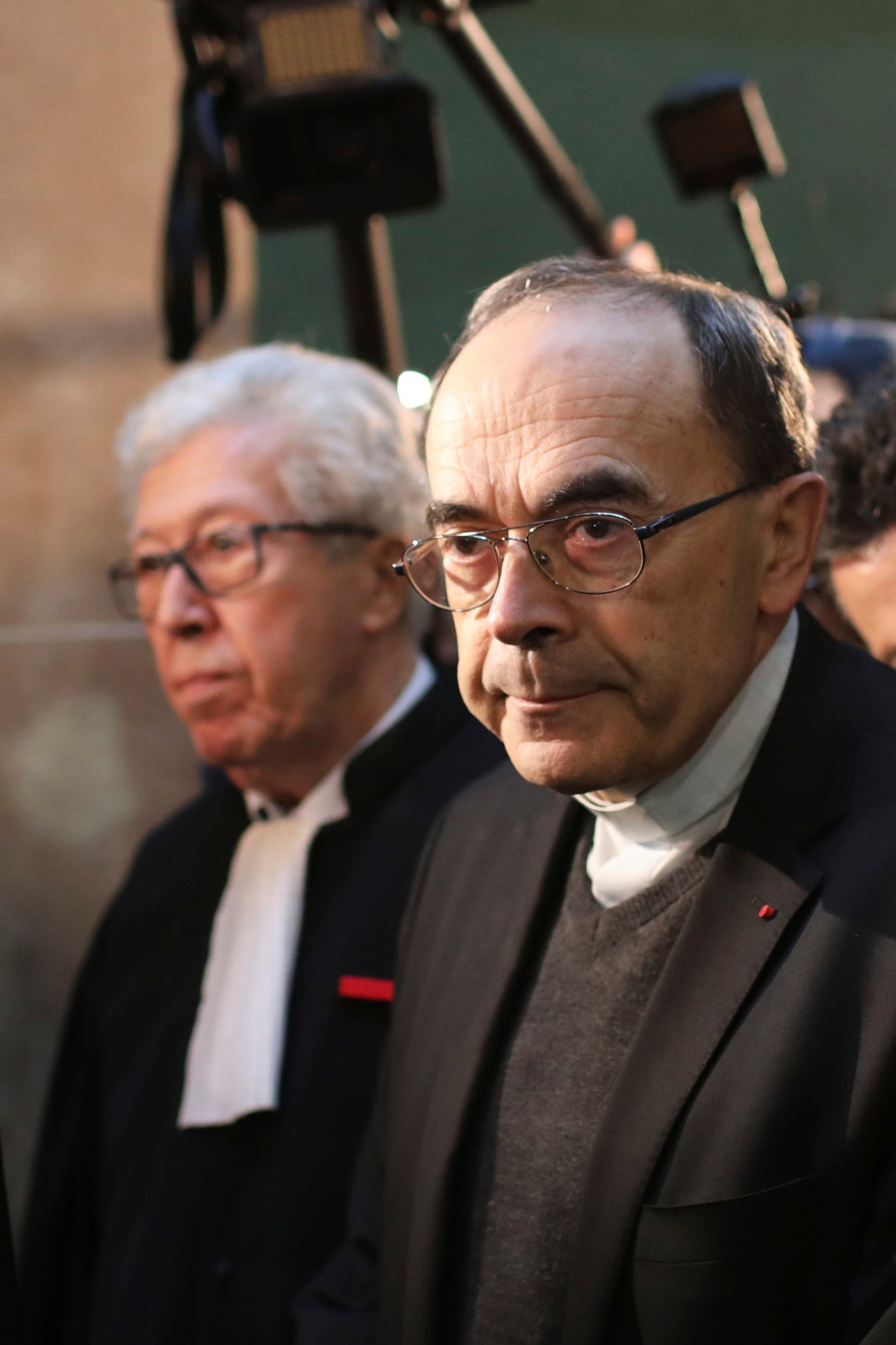 Cardinal Philippe Barbarin, right, arrives at the Lyon courthouse to attend his trial, in Lyon, central France, Monday Jan. 7, 2019. The Roman Catholic Church faces another public reckoning when a French cardinal, Philippe Barbarin, goes on trial Monday for his alleged failure to report a pedophile priest who confessed to preying on Boy Scouts and whose victims want to hold one of France's highest church figures accountable. (AP Photo/Laurent Cipriani) France Church Sex Abuse