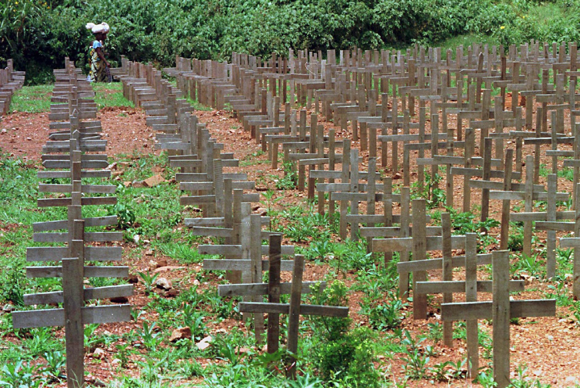 FILE - In this Dec. 1, 1996 file photo, rows of crosses mark a mass burial site of victims of the 1994 genocide near Kigali, Rwanda. A Rwandan man was found guilty Friday, May 22, 2009 of war crimes during his country's 1994 genocide, becoming the first person convicted under a new Canadian law that allows residents to be tried for crimes committed abroad. Desire Munyaneza, 42, faces a possible life sentence. He was found guilty of all seven charges against him that include genocide, crimes against humanity and war crimes for his alleged role in the rape and slaughter of at least 500,000 Tutsis and moderate Hutus in Rwanda. (AP Photo/The Canadian Press, Paul Chiasson, File) RUANDA GENOZID ERINNERUNG