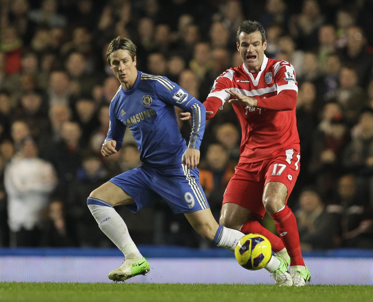 Chelsea's Fernando Torres, left, competes with Queens Park Rangers' Ryan Nelsen during their English Premier League soccer match at Stamford Bridge, London, Wednesday, Jan. 2, 2013. (AP Photo/Sang Tan)
