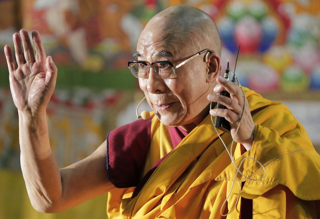 The Dalai Lama waves to devotees as he arrives to give a religious lecture in Yokohama, near Tokyo, Sunday, Nov. 4, 2012. The Tibetan spiritual leader arrived in Japan Saturday for a 12-day visit to deliver speeches and to take part in a symposium. (AP Photo/Itsuo  Inouye)