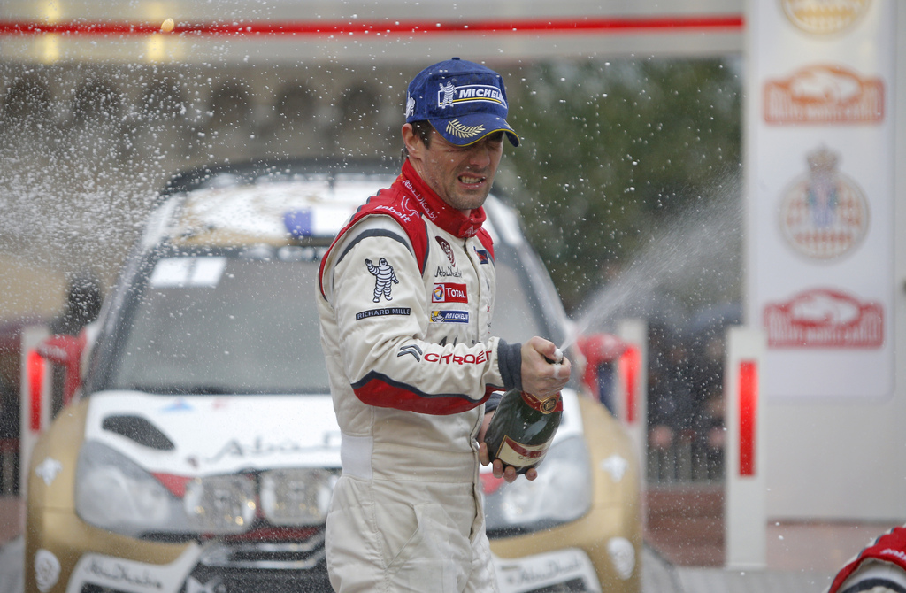 World champion Sebastien Loeb of France sprays champagne after winning the 81st Rally of Monte Carlo, Sunday, Jan. 20, 2013, in Monaco. Nine-time world champion Sebastien Loeb of France won the Monte Carlo Rally for the seventh time in the past eight races on Saturday. The Citroen driver, competing in the first of only four races this season after going into semi-retirement, won ahead of countryman Sebastien Ogier and Daniel Sordo of Spain after race organizers cancelled the day's final two stages on safety grounds. (AP Photo/Lionel Cironneau)
