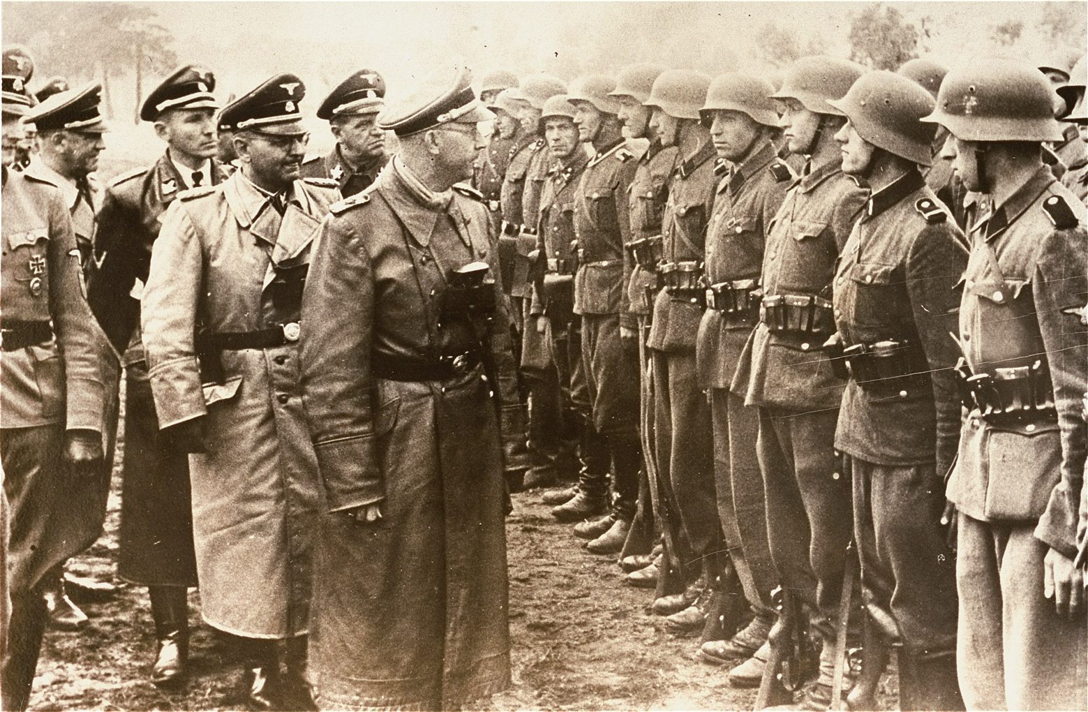 The June 3, 1944 photo provided by the US Holocaust Memorial Museum shows Heinrich Himmler, centre,  SS Reichsfuehrer-SS, head of the Gestapo and the Waffen-SS, and Minister of the Interior of Nazi Germany from 1943 to 1945, as he reviews troops of the Galician SS-Volunteer Infantry Division   Michael Karkoc  a top commander whose Nazi SS-led unit is blamed for burning villages filled with women and children lied to American immigration officials to get into the United States and has been living in Minnesota since shortly after World War II, according to evidence uncovered by The Associated Press. Michael Karkoc became a member of the Galician division after the Ukrainian Self Defense Legion was incorporated into it near the end of the war. (AP photo/ U.S. Holocaust Memorial Museum, courtesy of Atlantic Foto Verlag Berlin) Germany US Nazi Commander