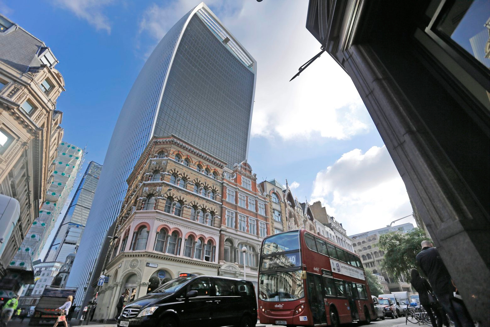 London's Walkie Talkie building, center rear, was judged UK's worst building in London, Wednesday, Sept. 2, 2015. A City of London skyscraper, nicknamed the Walkie Talkie, has won the annual Carbuncle Cup, awarded to a building judged to be the UK's worst. In its short history, the 37-storey office tower has melted parked cars and critics have compared its three-storey roof garden to an airport terminal. (AP Photo/Frank Augstein) BRITAIN WORST BUILDING