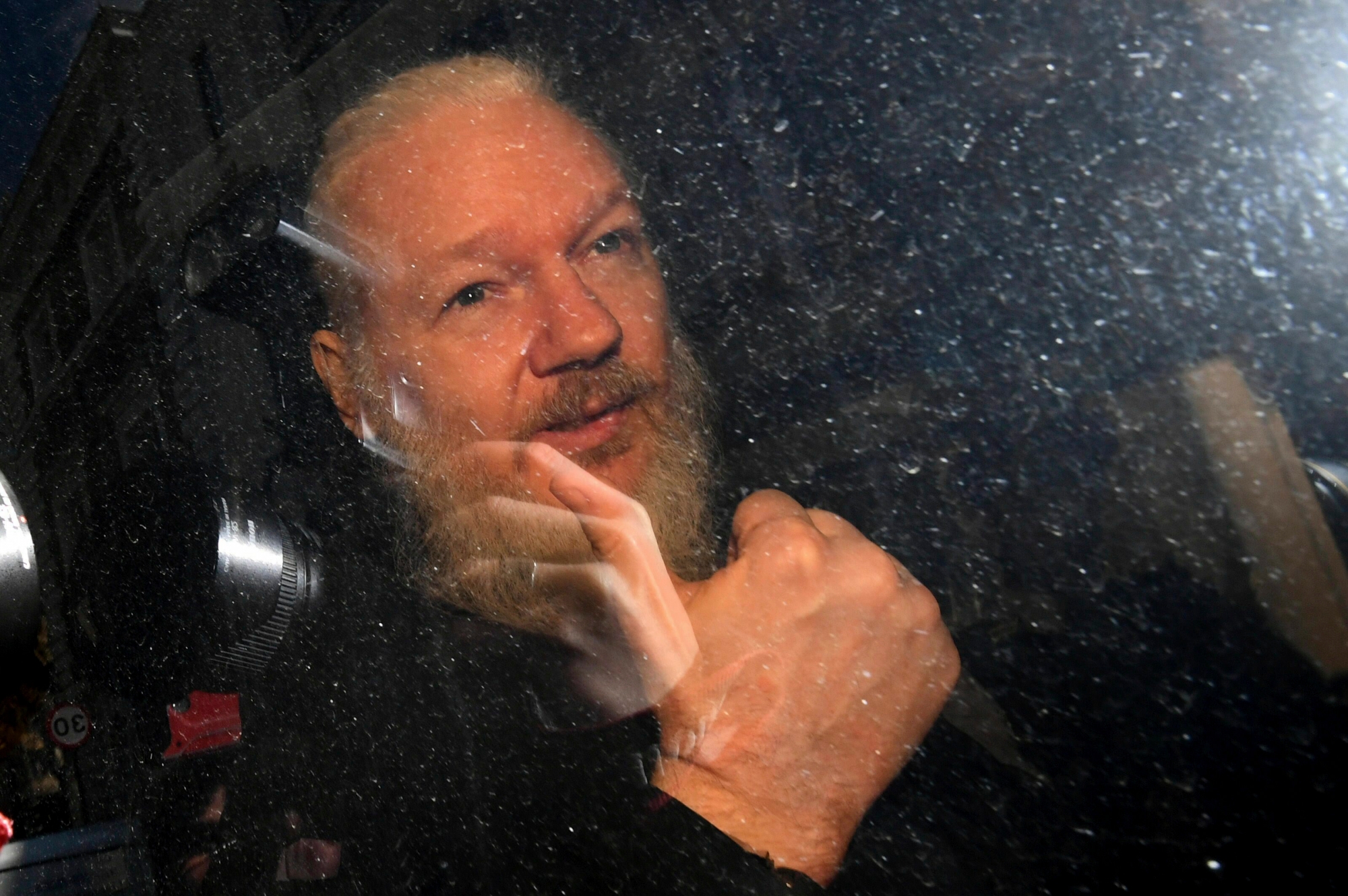 Julian Assange gestures as he arrives at Westminster Magistrates' Court in London, after the WikiLeaks founder was arrested by officers from the Metropolitan Police and taken into custody Thursday April 11, 2019. Police in London arrested WikiLeaks founder Assange at the Ecuadorean embassy Thursday, April 11, 2019 for failing to surrender to the court in 2012, shortly after the South American nation revoked his asylum .(Victoria Jones/PA via AP) Britain Wikileaks Assange Arrested