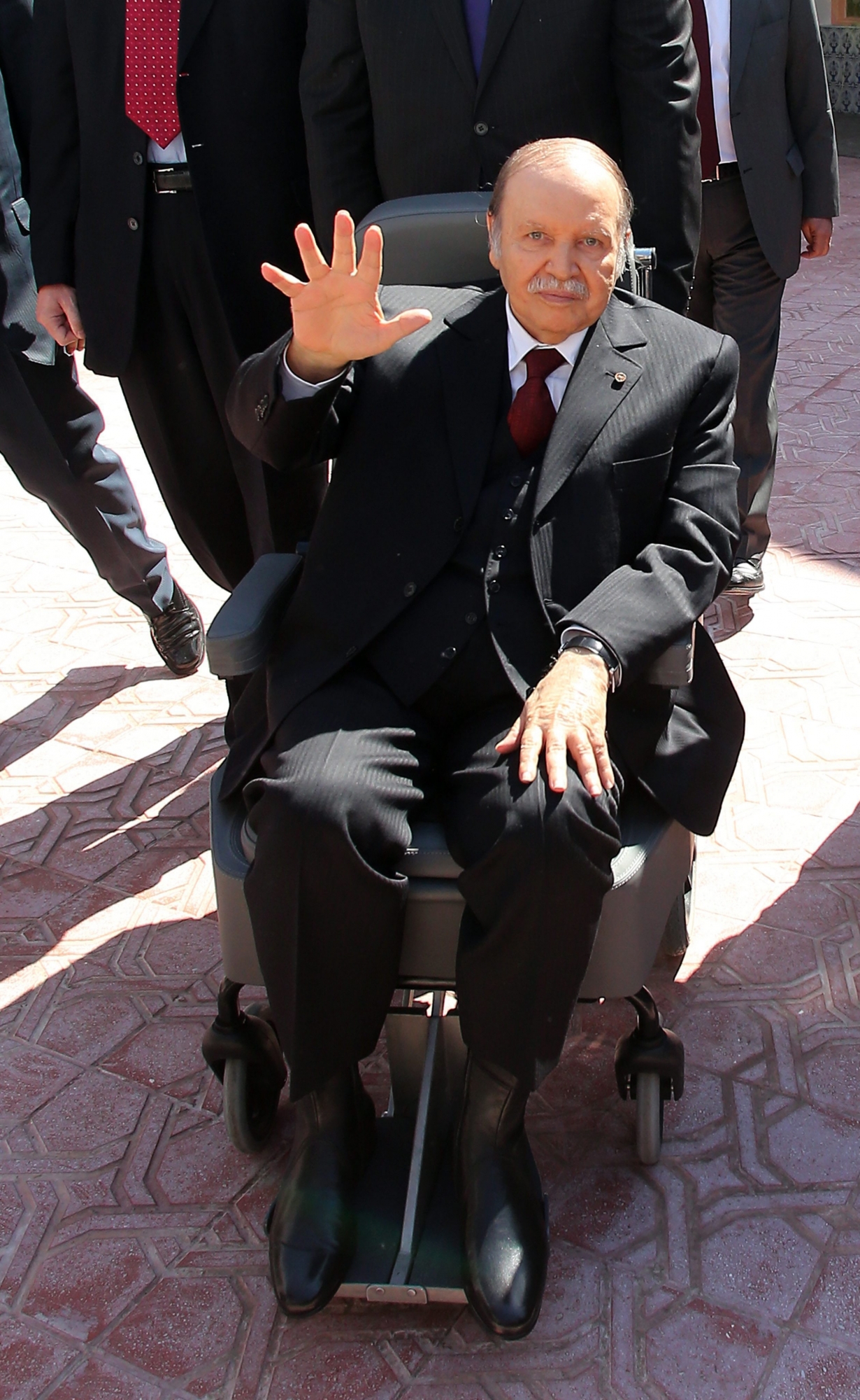 epa04169940 Algerian President Abdelaziz Bouteflika, who is seeking a fourth term, leaves after voting at a polling station in Algiers, Algeria, 17 April 2014. Bouteflika arrived in a wheelchair at a school in the capital where he cast his ballot. The 77-year-old incumbent, who has uttered only a few sentences in public since suffering a stroke last year, was accompanied to the polling station by his brother Said, who acts as his special adviser.  EPA/MOHAMED MESSARA ALGERIA PRESIDENTIAL ELECTIONS 2014