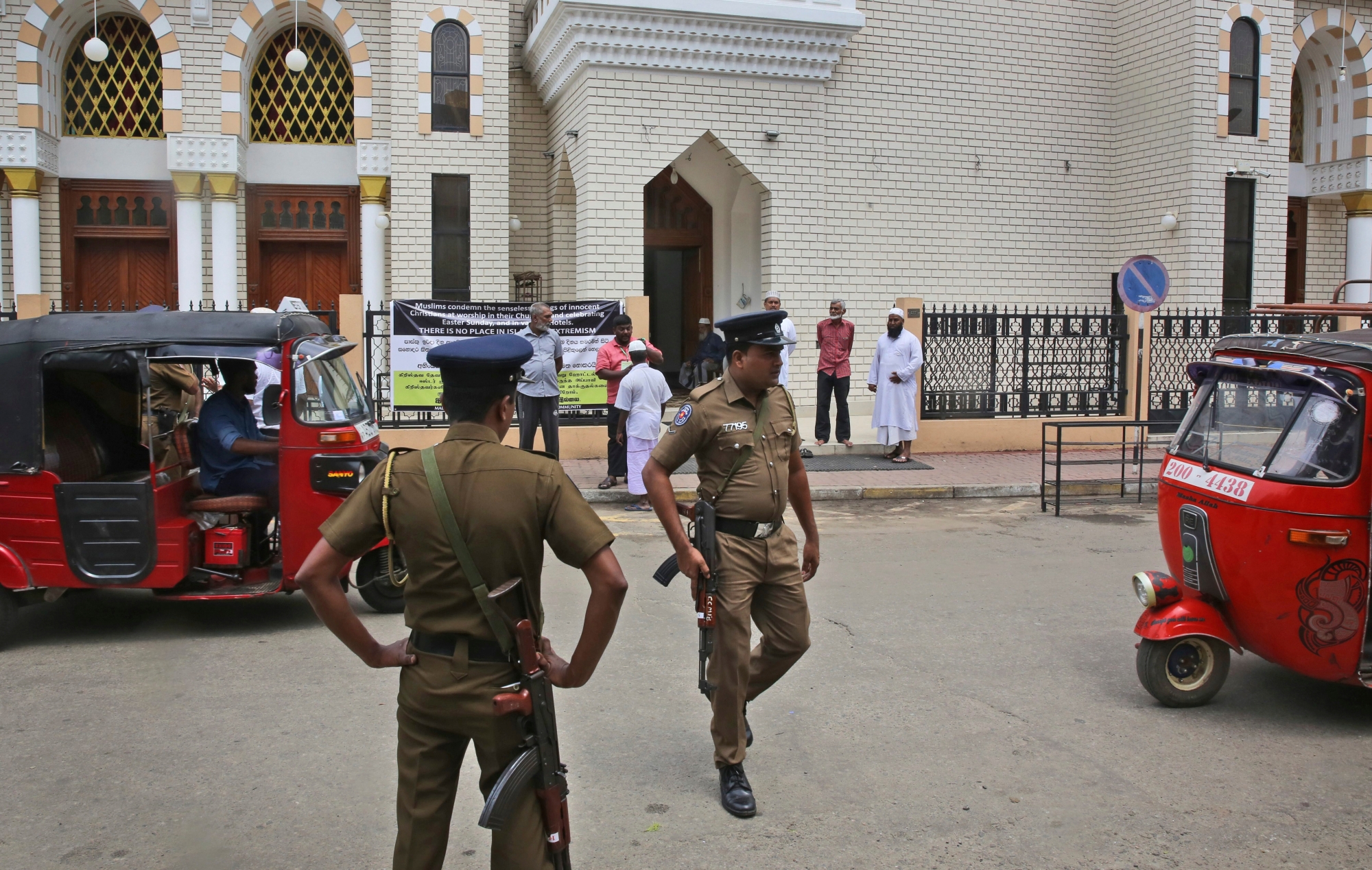 Sri Lankan policemen stand guard outside a mosque before the Friday prayers, in Colombo, Sri Lanka, Friday, April 26, 2019. Across Colombo, there was a visible increase of security as authorities warned of another attack and pursued suspects that could have access to explosives. Authorities had told Muslims to pray at home rather than attend communal Friday prayers that are the most important religious service for the faithful. At one mosque in Colombo where prayers were still held, police armed with Kalashnikov assault rifles stood guard outside. (AP Photo/Manish Swarup) Sri Lanka Blasts