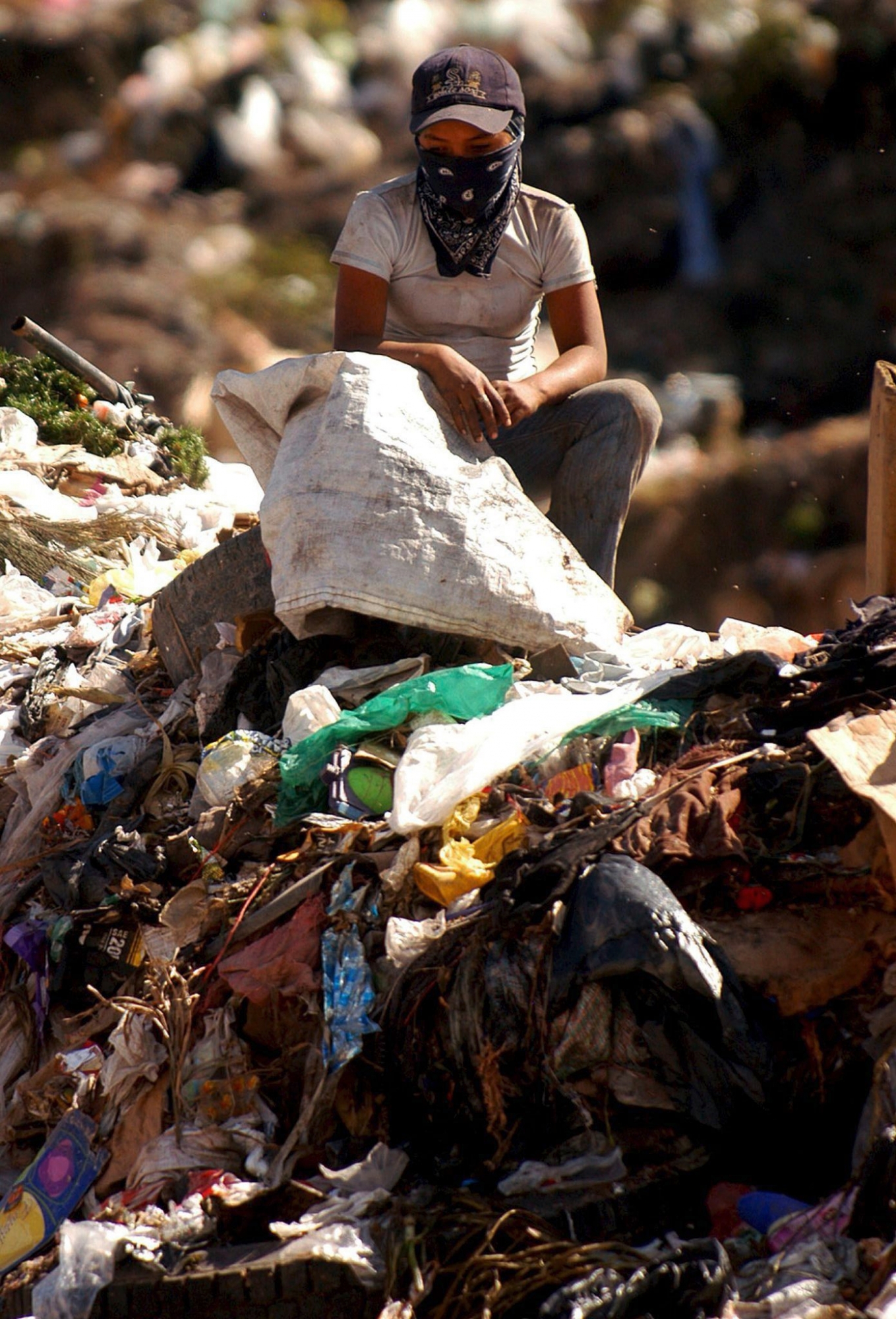 epa00910519 A young girl sits among a mountain of garbage at the municipal dump in eastern Tegucigalpa, Monday 22 January 2007. Honduras' Minister of Finance Rebeca Santos announced that her country had reached an agreement with the Inter-American Development Bank (IADB) for debt relief of US$ 1.4 billion dollars. The decision by the bank will be formalized between the 16th and 20th of March in Guatemala City (Guatemala), during the IADB¥s governor's assembly.  EPA/Gustavo Amador HONDURAS DEBT RELIEF