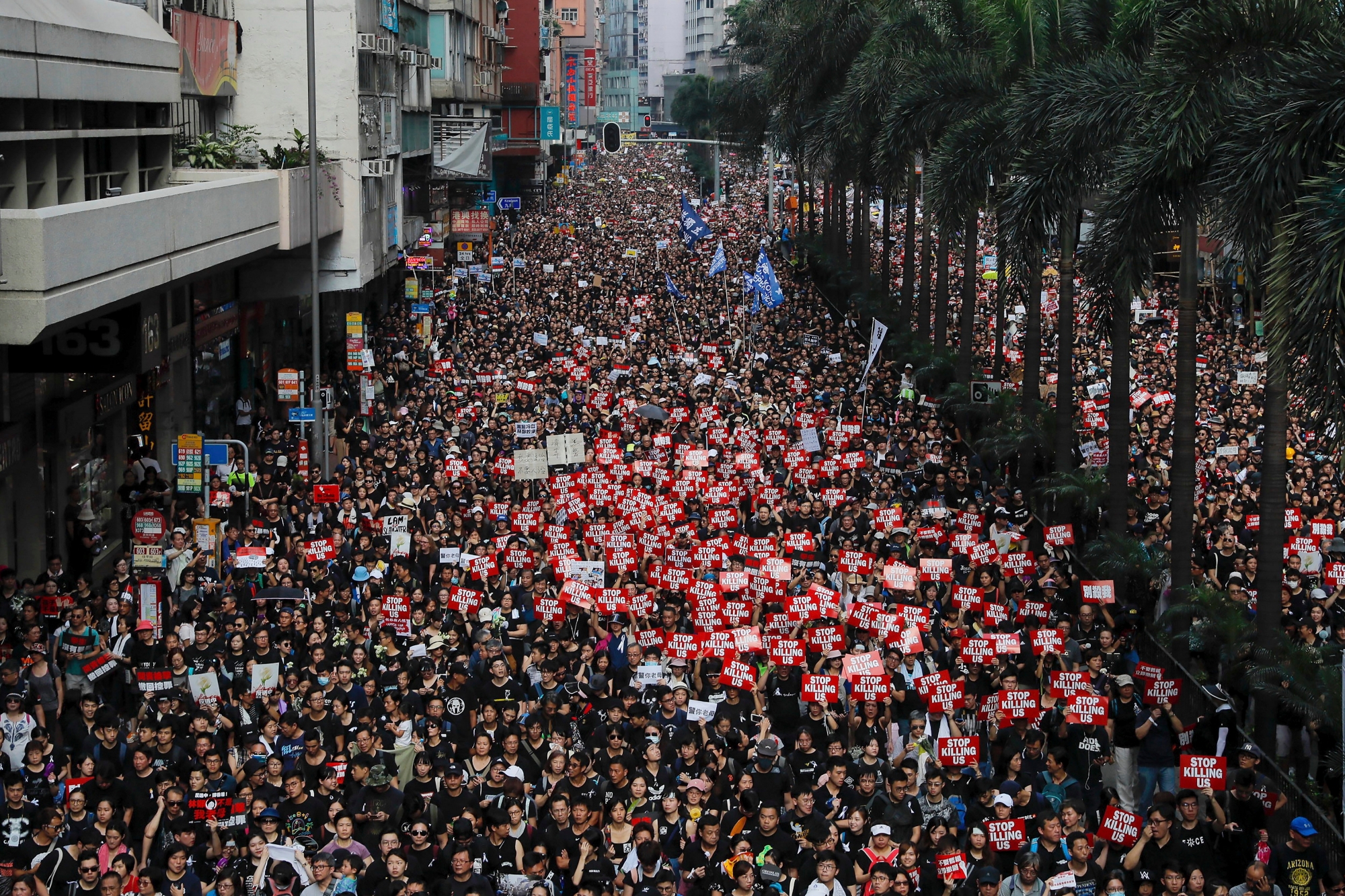 Tens of thousands of protesters carry posters and banners march through the streets as they continue to protest an extradition bill, Sunday, June 16, 2019, in Hong Kong. Hong Kong residents Sunday continued their massive protest over an unpopular extradition bill that has highlighted the territory's apprehension about relations with mainland China, a week after the crisis brought as many as 1 million into the streets. (AP Photo/Kin Cheung) Hong Kong Extradition Law