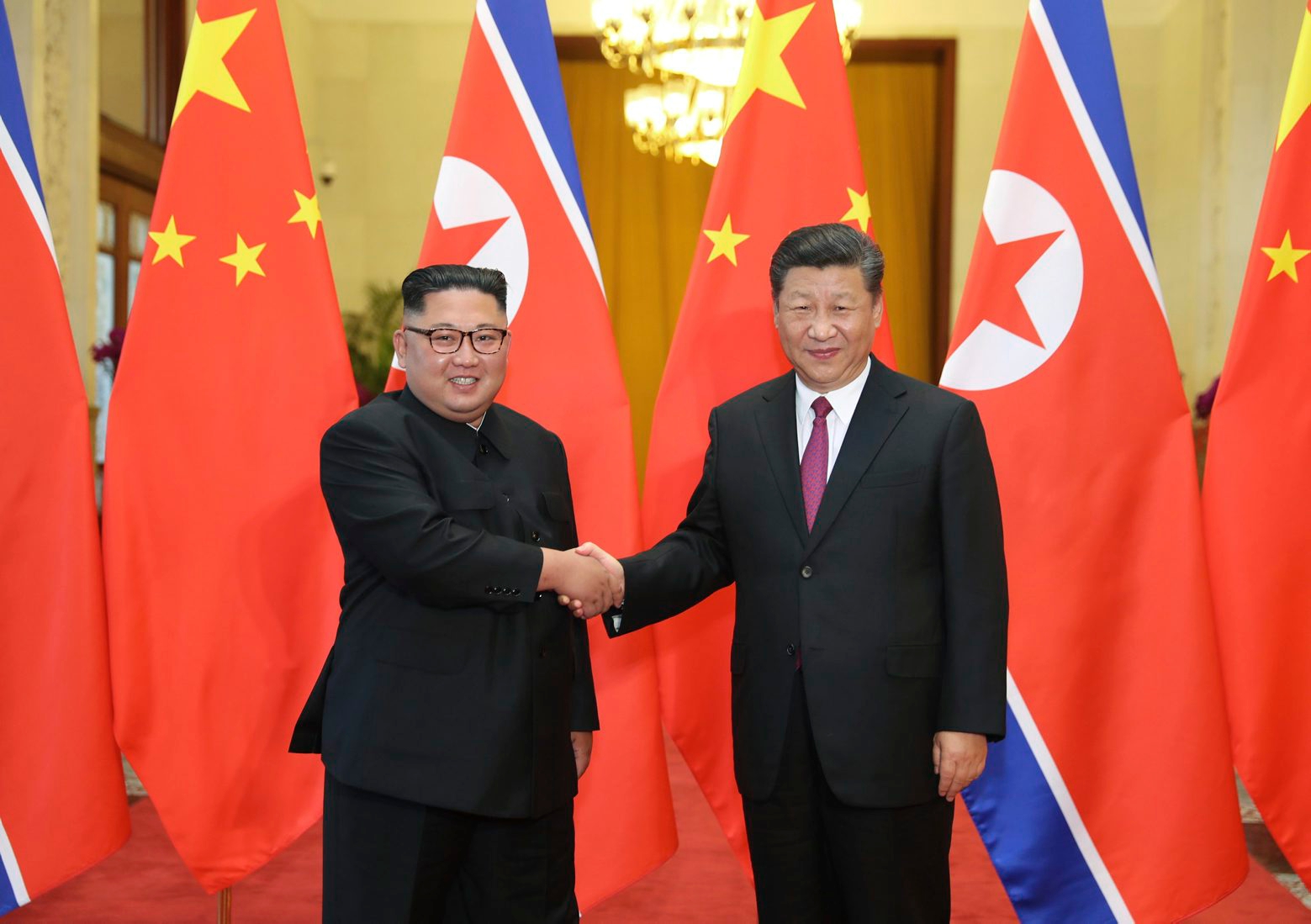 FILE - In this June 19, 2018, file photo released by China's Xinhua News Agency, Chinese President Xi Jinping, right, poses with North Korean leader Kim Jong Un for a photo during a welcome ceremony at the Great Hall of the People in Beijing. Chinese state media say President Xi Jinping will make a state visit to North Korea this week. State broadcaster CCTV said in its evening news program on Monday that Xi will meet with North Korean leader Kim Jong Un during a visit Thursday and Friday. (Ju Peng/Xinhua via AP, File) China North Korea Summit