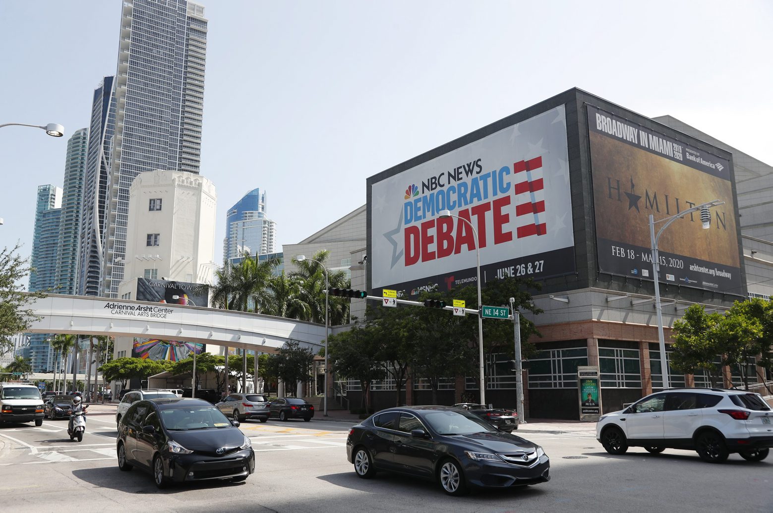 Cars pass by a billboard advertising the Democratic Presidential Debates across from the Knight Concert Hall at the Adrienne Arsht Center for the Performing Arts of Miami-Dade County, Tuesday, June 25, 2019, in Miami. The debates are scheduled to take place June 26 and 27, with 10 candidates competing each night. (AP Photo/Wilfredo Lee) Election 2020 Debate