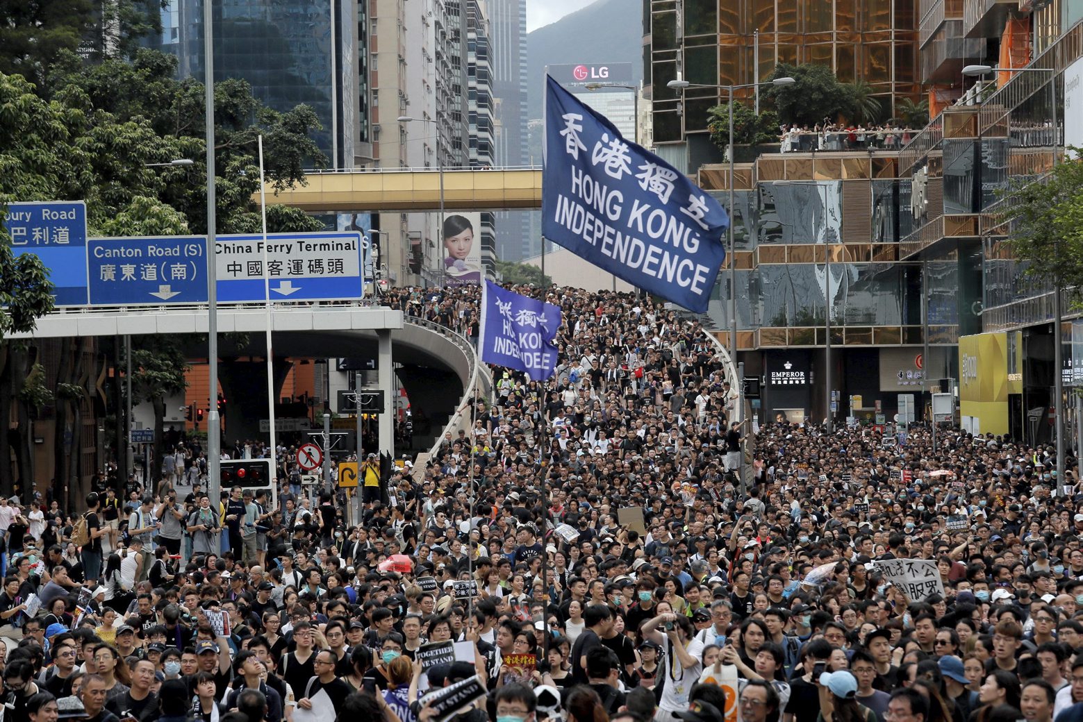 Protesters march with a flag calling for Hong Kong independence in Hong Kong on Sunday, July 7, 2019. Thousands of people, many wearing black shirts and some carrying British flags, were marching in Hong Kong on Sunday, targeting a mainland Chinese audience as a month-old protest movement showed no signs of abating. (AP Photo/Kin Cheung) APTOPIX Hong Kong Protests
