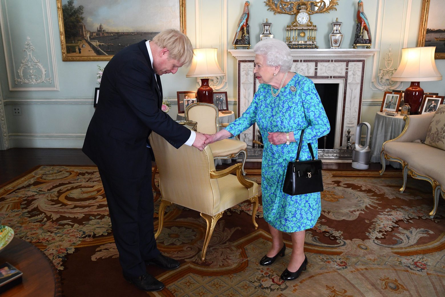 epa07737751 Britain's Queen Elizabeth II welcomes newly elected leader of the Conservative party Boris Johnson during an audience in Buckingham Palace, London, Britain, 24 July 2019 where she invited him to become Prime Minister and form a new government. Former London mayor and foreign secretary Boris Johnson is taking over the post after his election as party leader was announced the previous day. Theresa May stepped down as British Prime Minister following her resignation as Conservative Party leader on 07 June.  EPA/VICTORIA JONES / POOL BRITAIN GOVERNMENT PRIME MINISTER