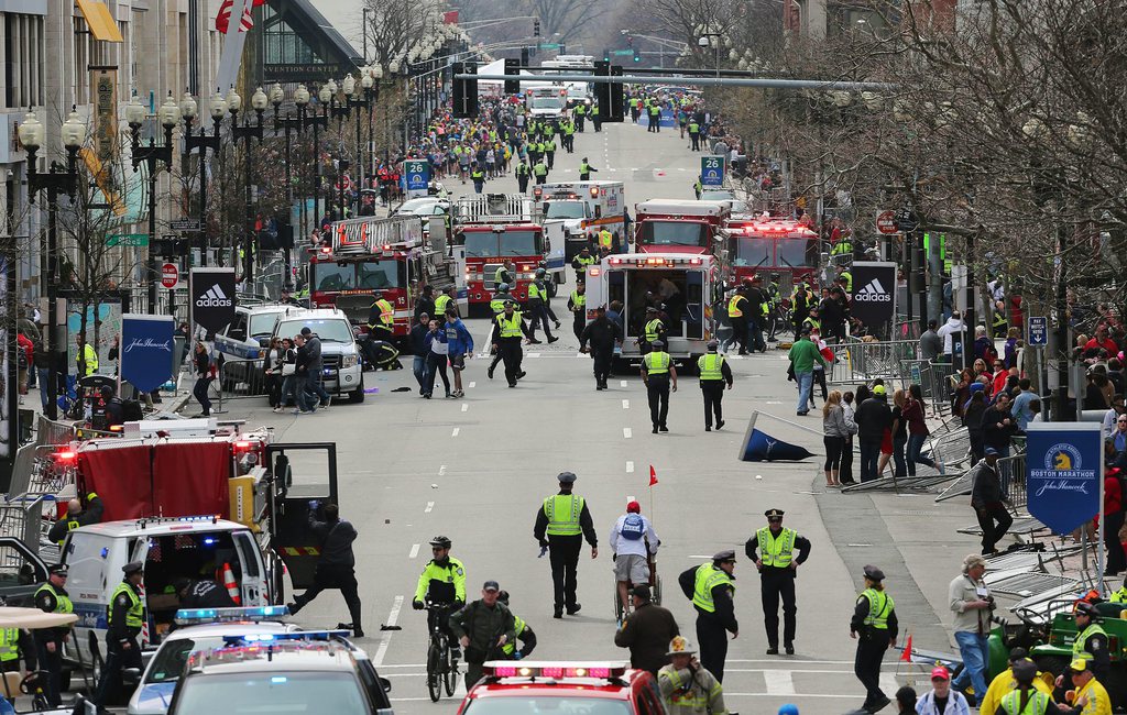 Medical workers respond following an explosion at the 2013 Boston Marathon in Boston, Monday, April 15, 2013. Two explosions shattered the euphoria of the Boston Marathon finish line on Monday, sending authorities out on the course to carry off the injured while the stragglers were rerouted away from the smoking site of the blasts. (AP Photo/The Boston Globe, David L Ryan)  MANDATORY CREDIT